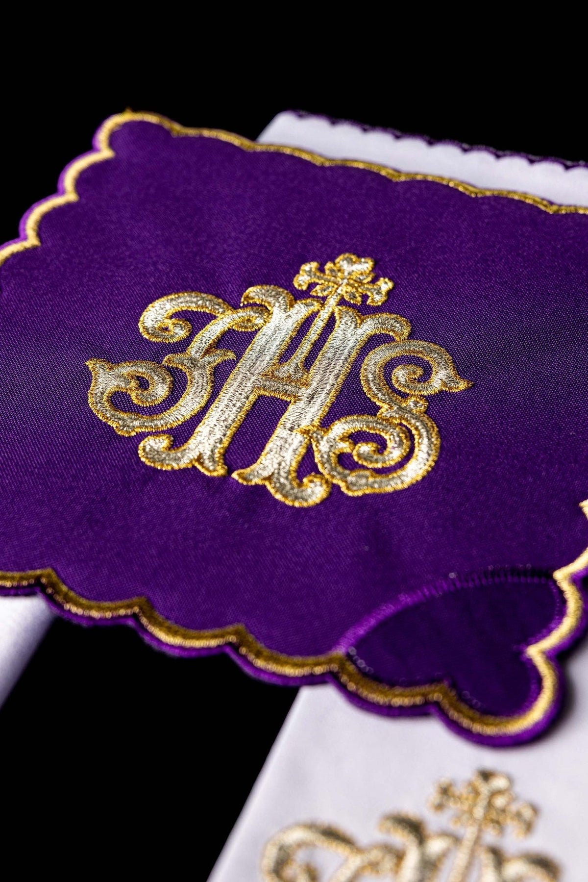 Altar linen set close-up of purple corporal with gold IHS embroidery and scalloped edge