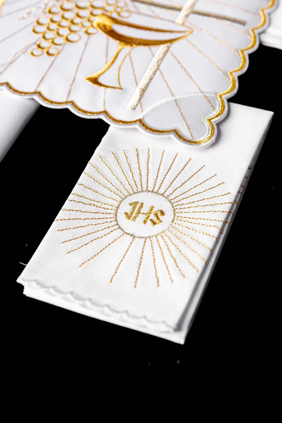 Altar linen set showing white lavabo towel with gold IHS monogram embroidery