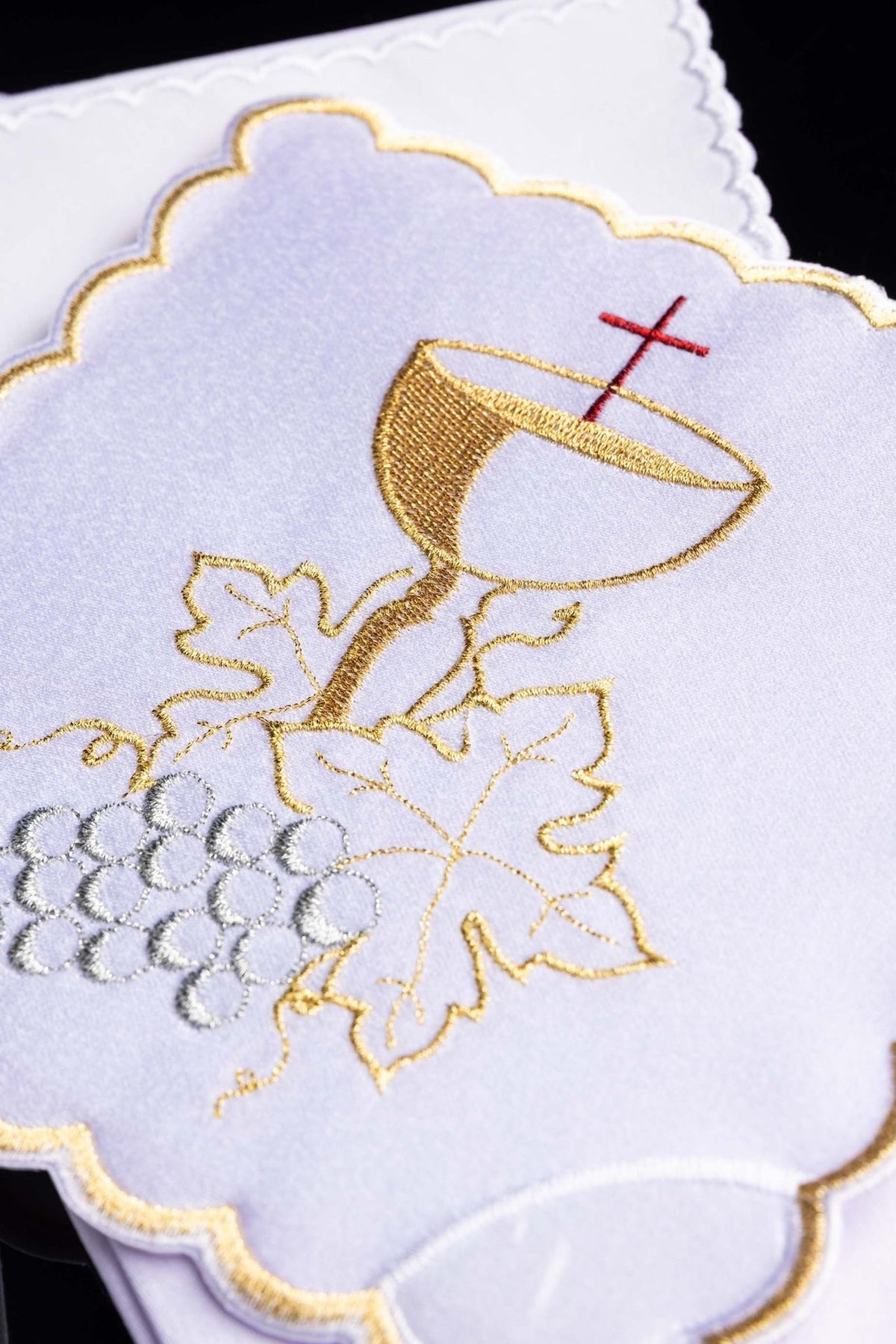 Altar linen set close-up showing embroidered gold chalice and vine with silver grapes