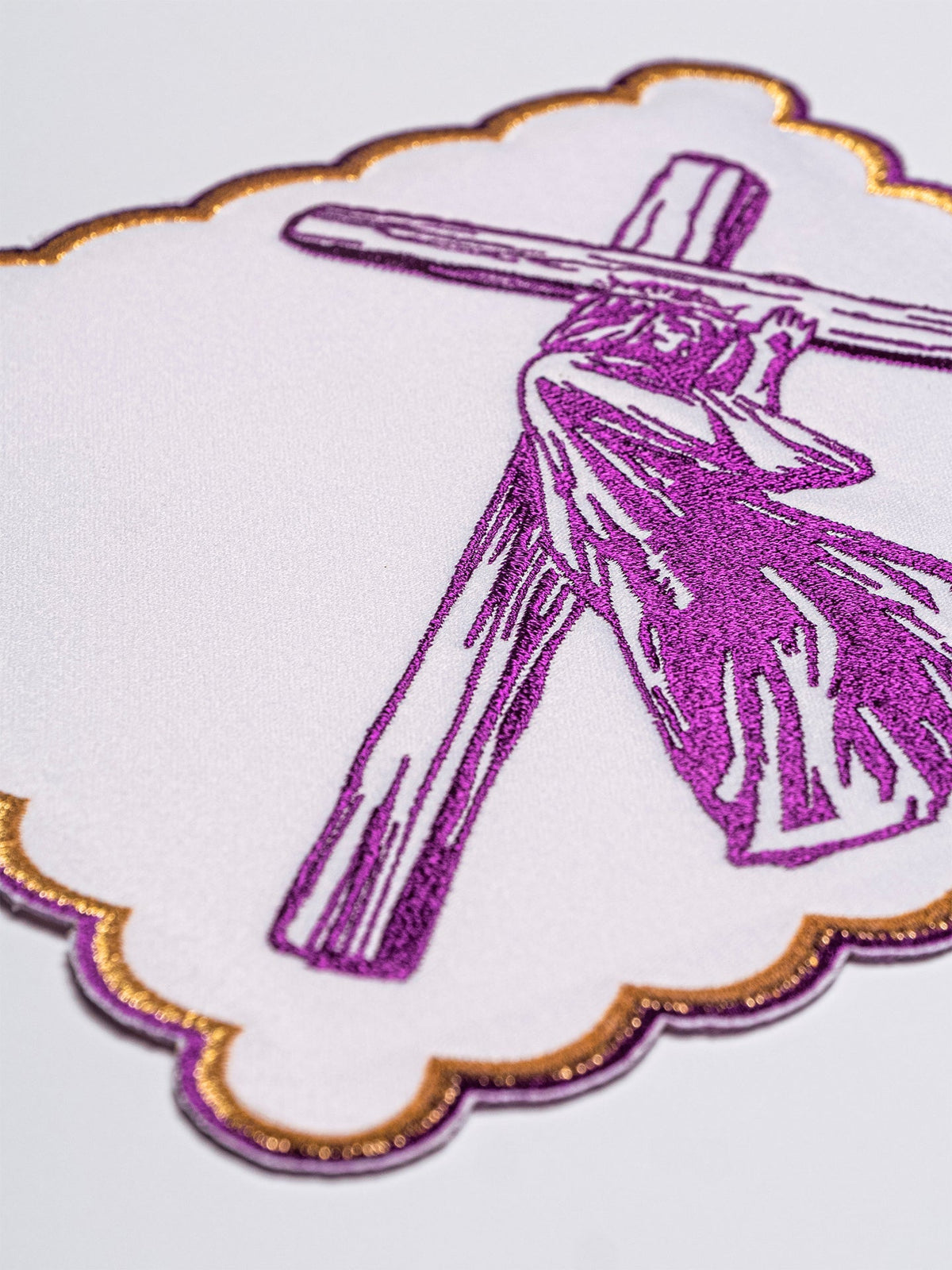 Altar linen set close-up with purple embroidered Stations of the Cross motif