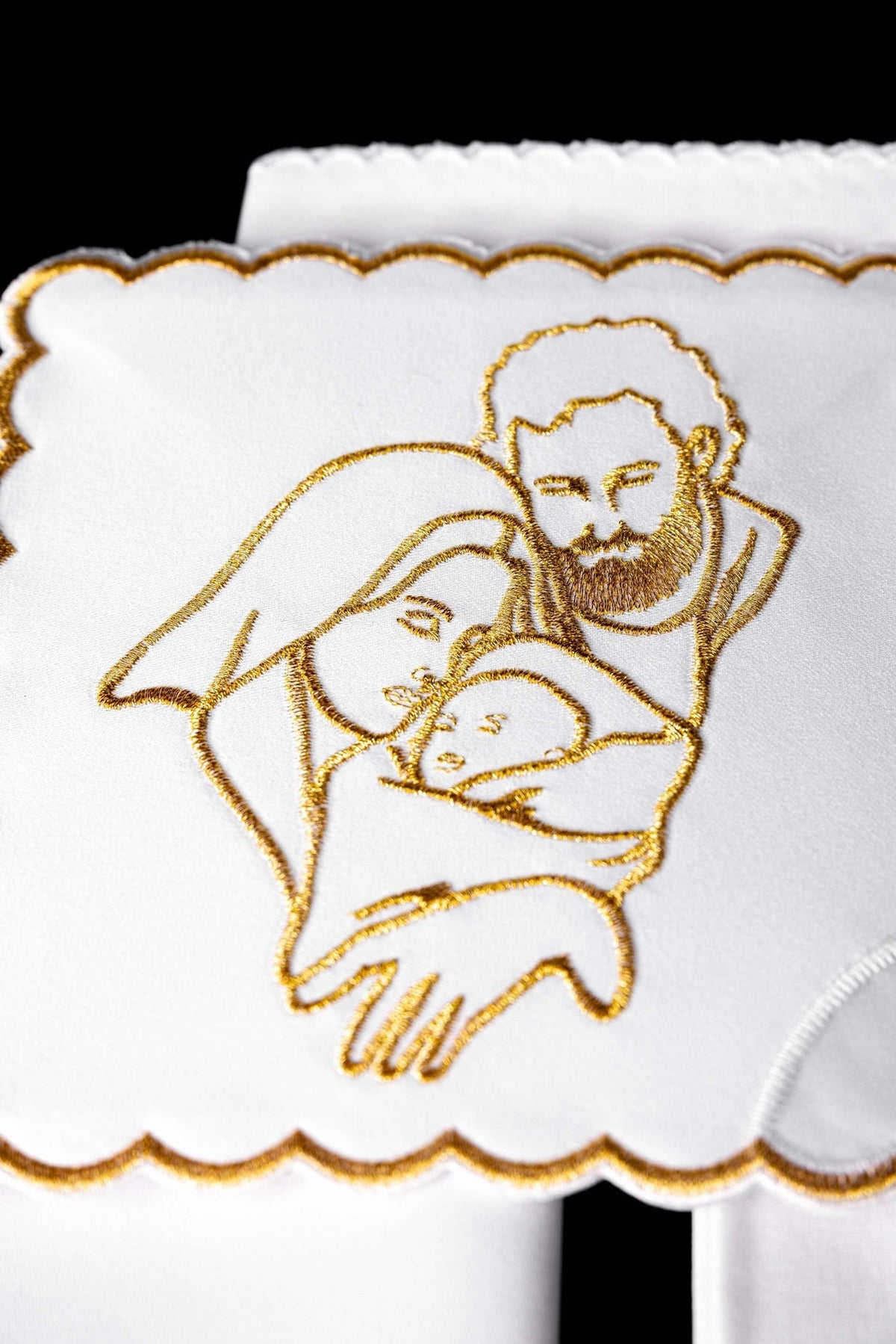 Altar linen set close-up of Holy Family embroidered in gold on white fabric