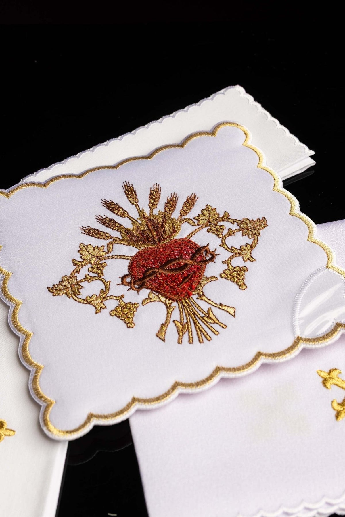 Altar linen set close-up with embroidered Sacred Heart of Jesus and gold scalloped border