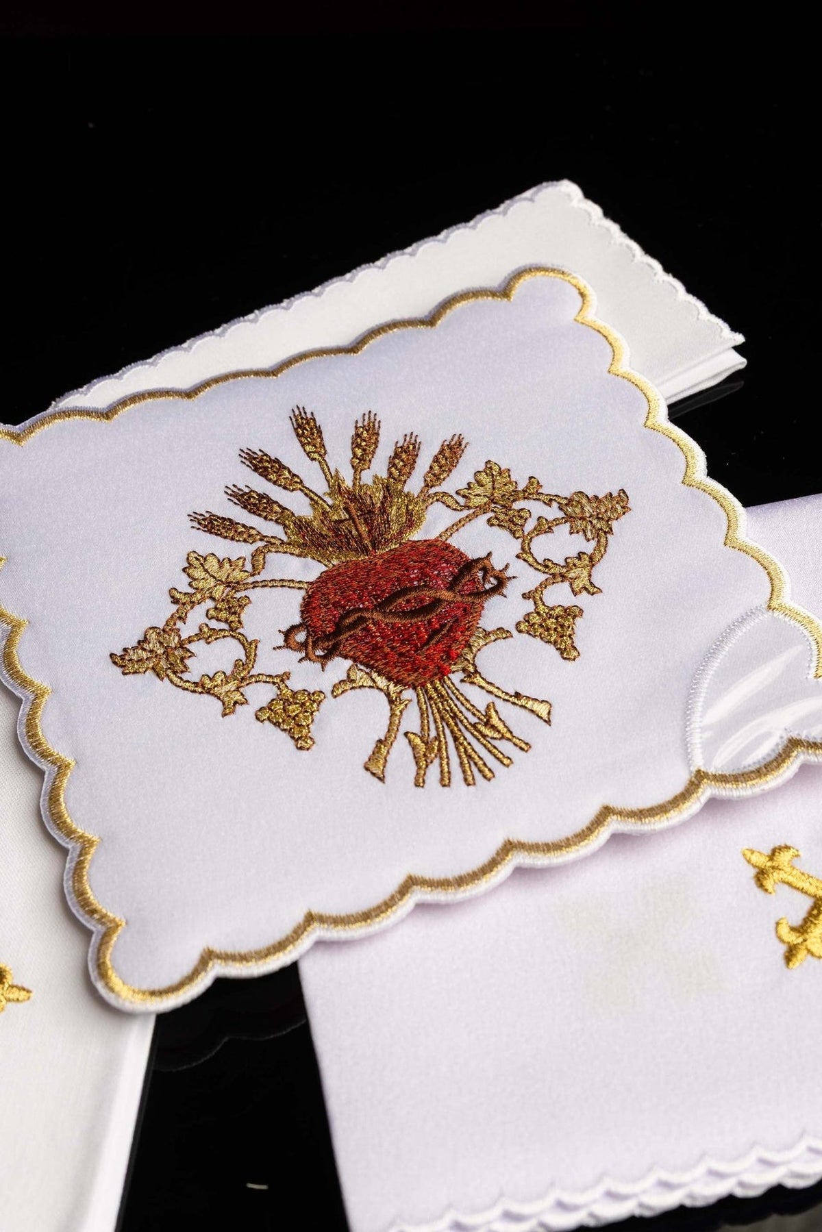 Altar linen set close-up showing Sacred Heart of Jesus embroidery and gold scalloped border