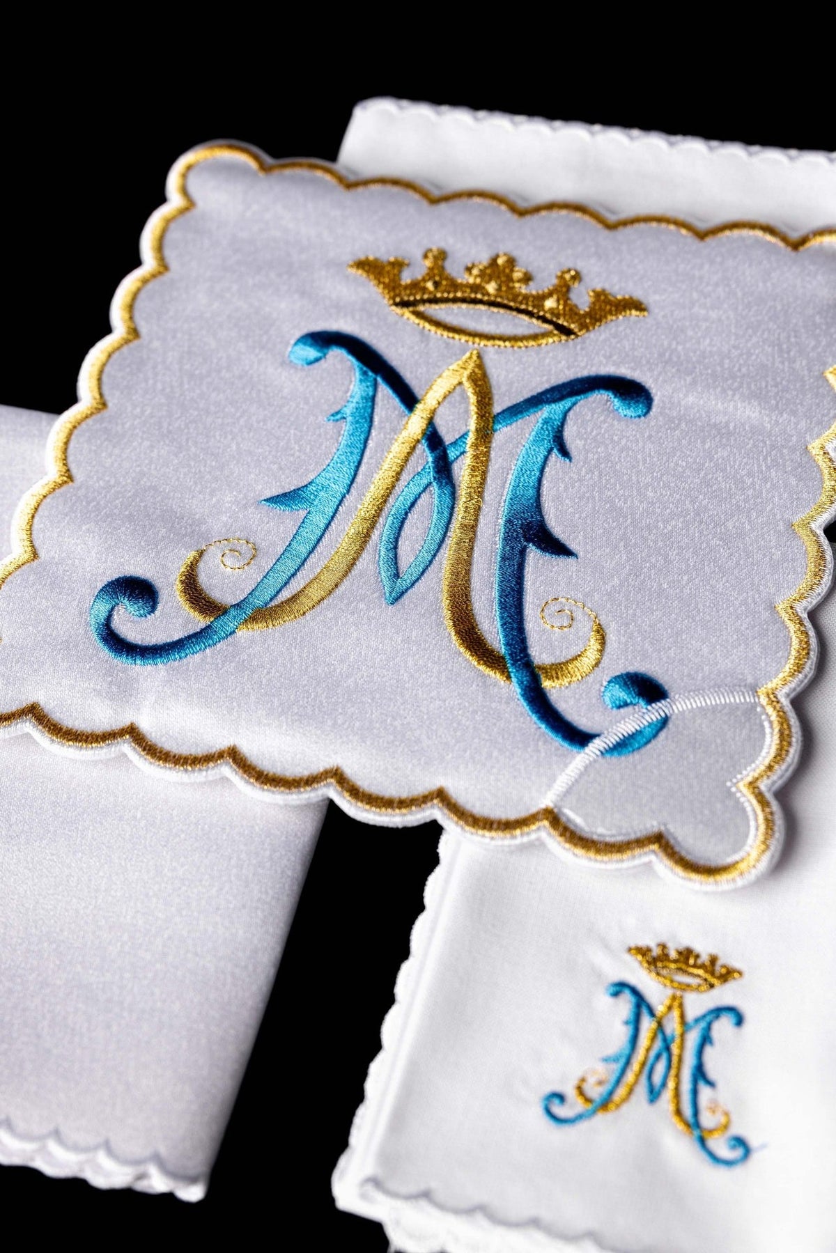 Altar linen set close-up of blue and gold Marian embroidery on white linen