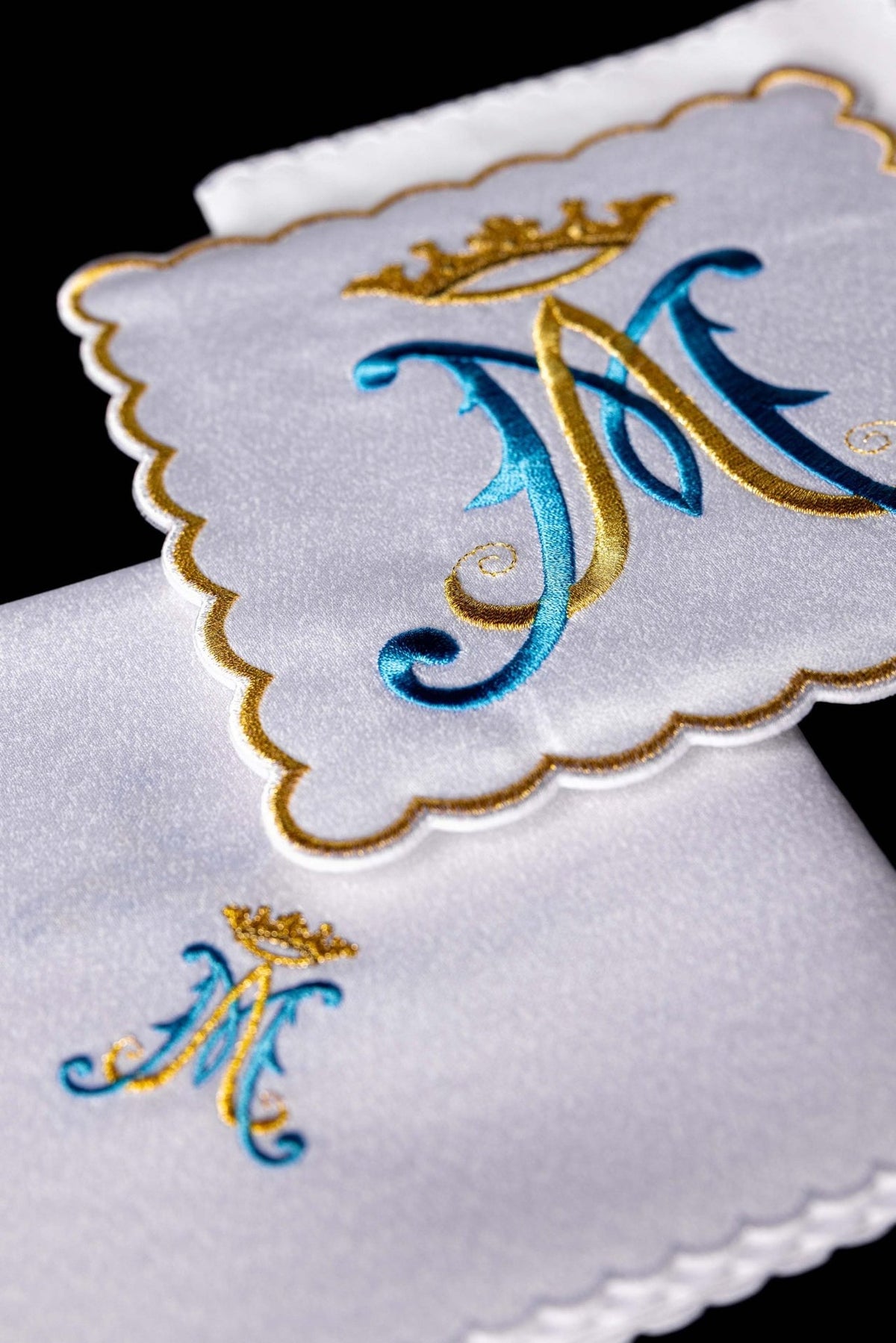 Altar linen set detail showing crowned Marian symbol and scalloped edging