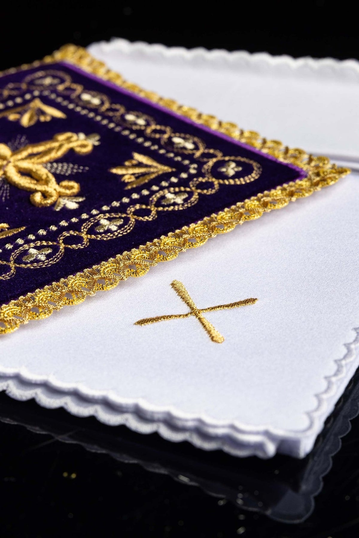 Altar linen set close-up showing white linen with scalloped edges and purple velvet pall