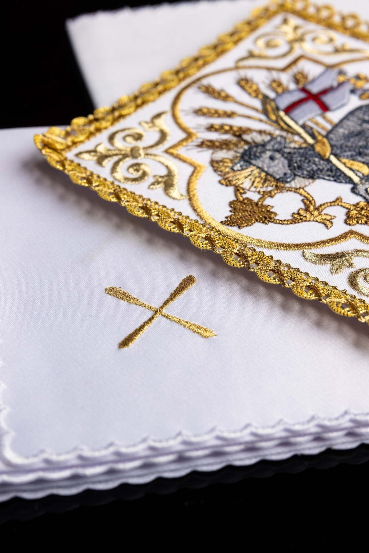 Altar linen set detail showing gold cross embroidery and scalloped white edges