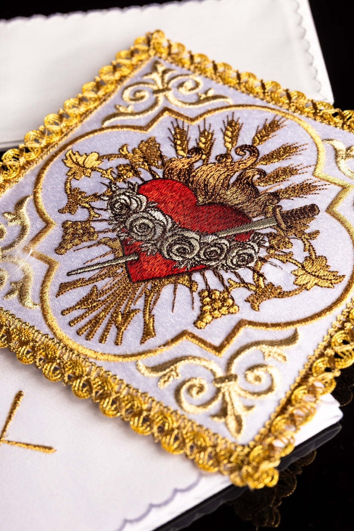 Altar linen set close-up showing the red Heart of Mary with roses, thorns and gold embroidery