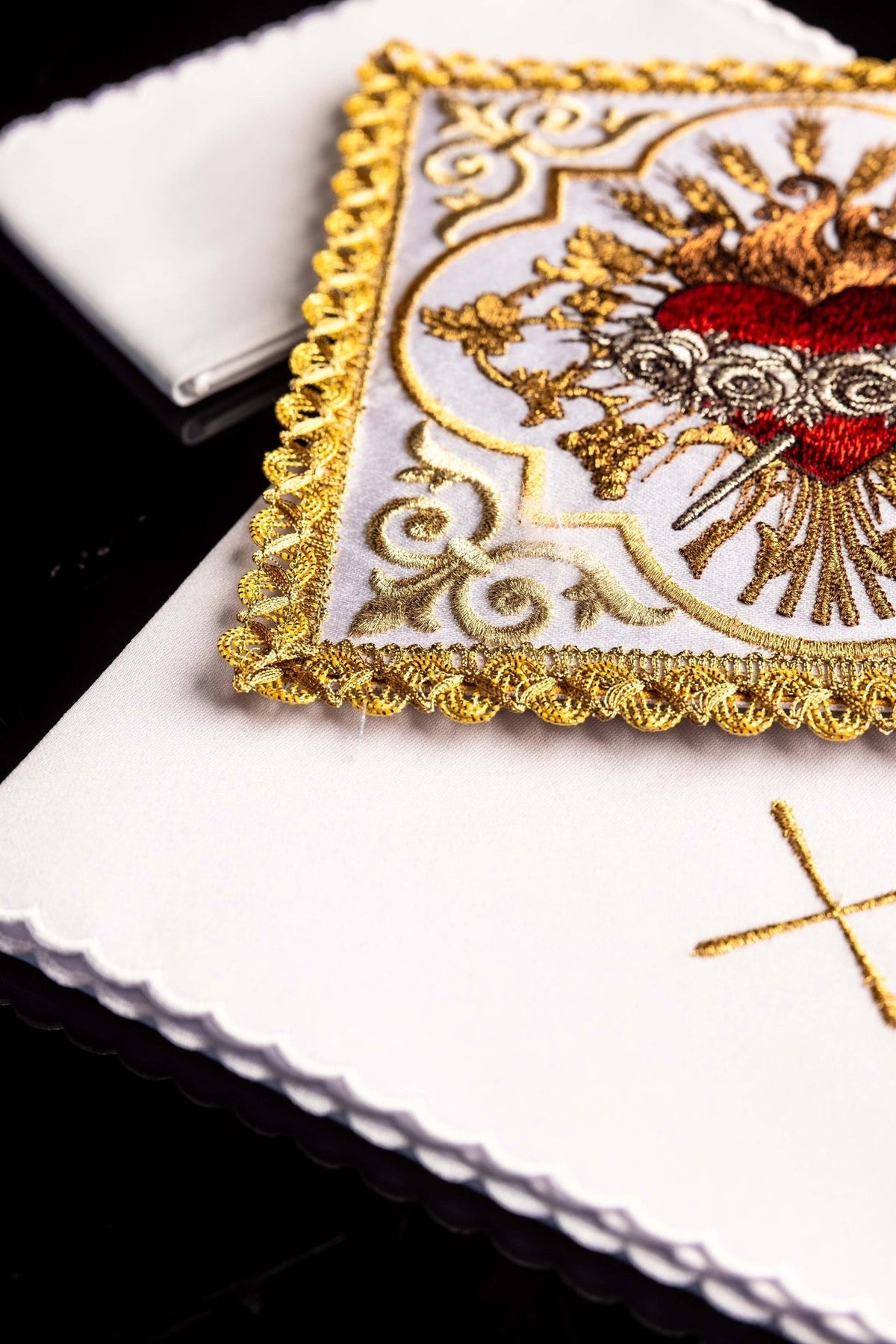 Altar linen set detail showing gold-trimmed Heart of Mary embroidery and scalloped white linen edges
