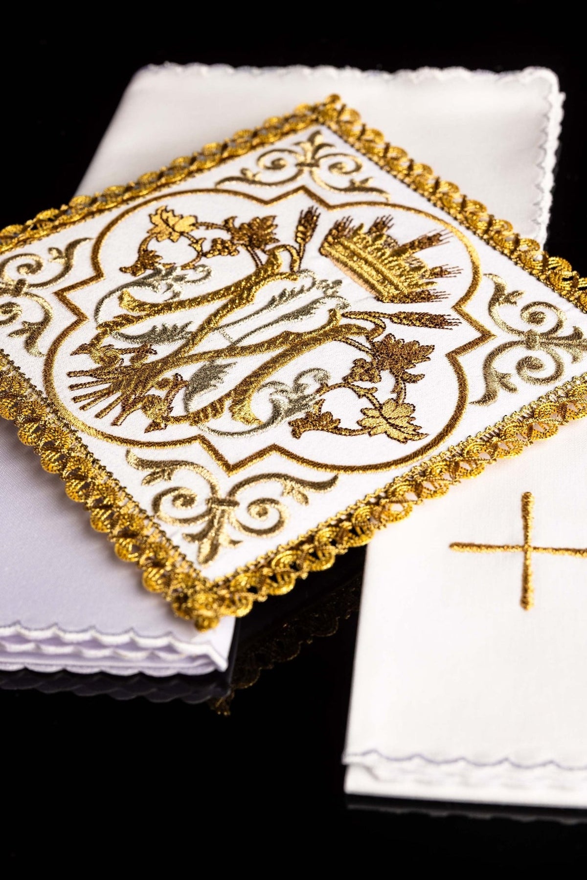 Altar linen set close-up showing Marian symbol, gold embroidery and ornate border