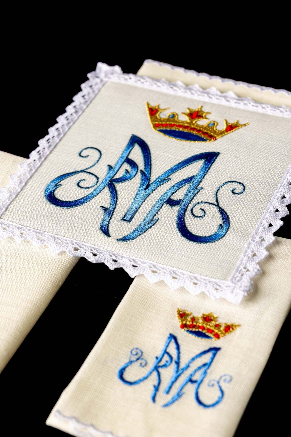 Altar linen set detail showing embroidered Marian symbol on linen fabric