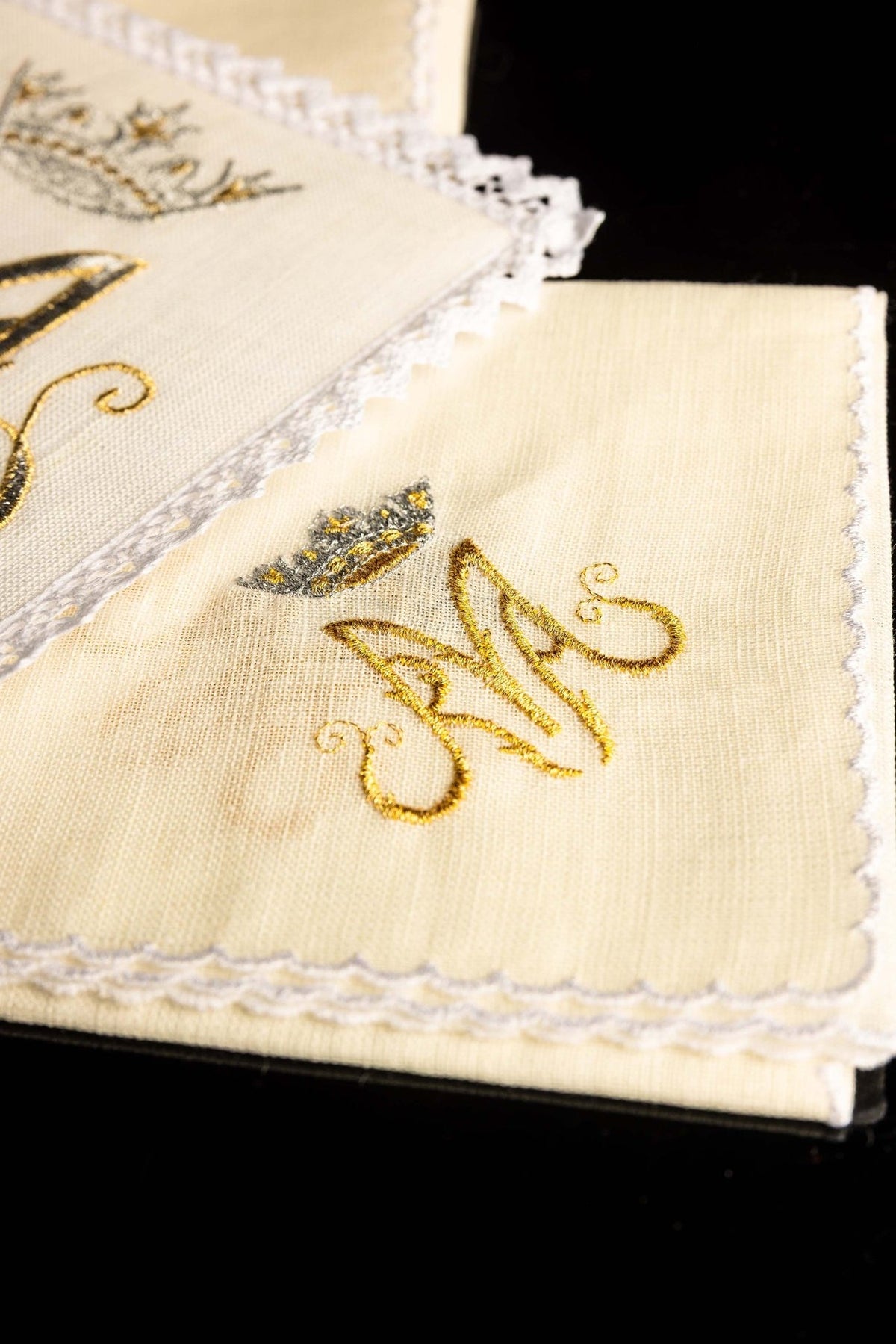Altar linen set close-up showing gold Marian symbol embroidery on linen with scalloped edging