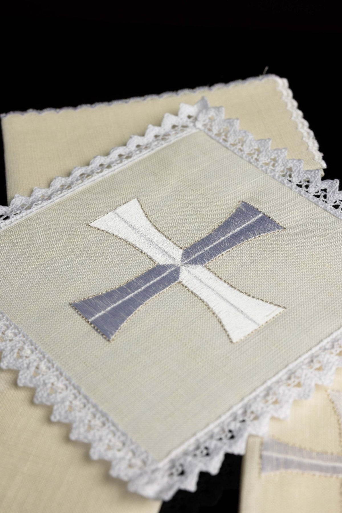 Altar linen set close-up showing silver and white cross embroidery with lace trim