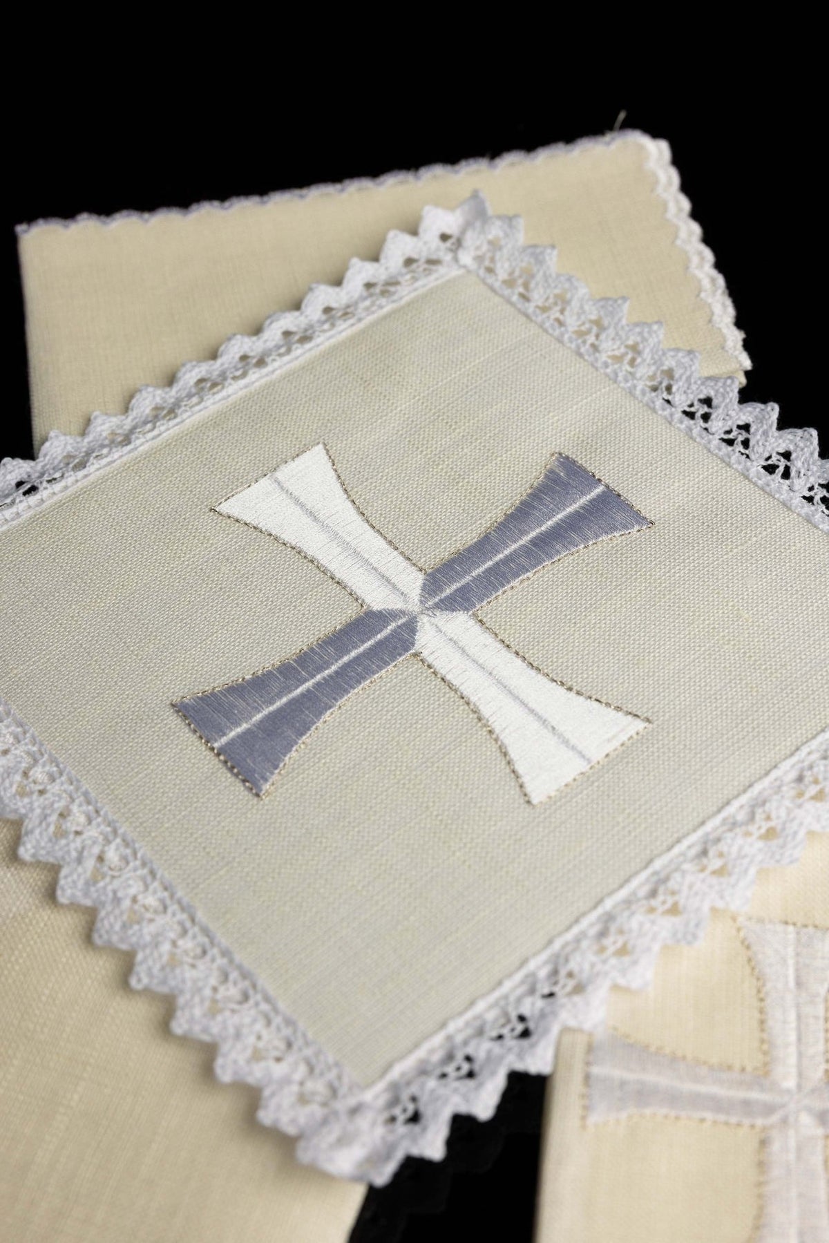 Altar linen set close-up of cross embroidery and decorative lace edging