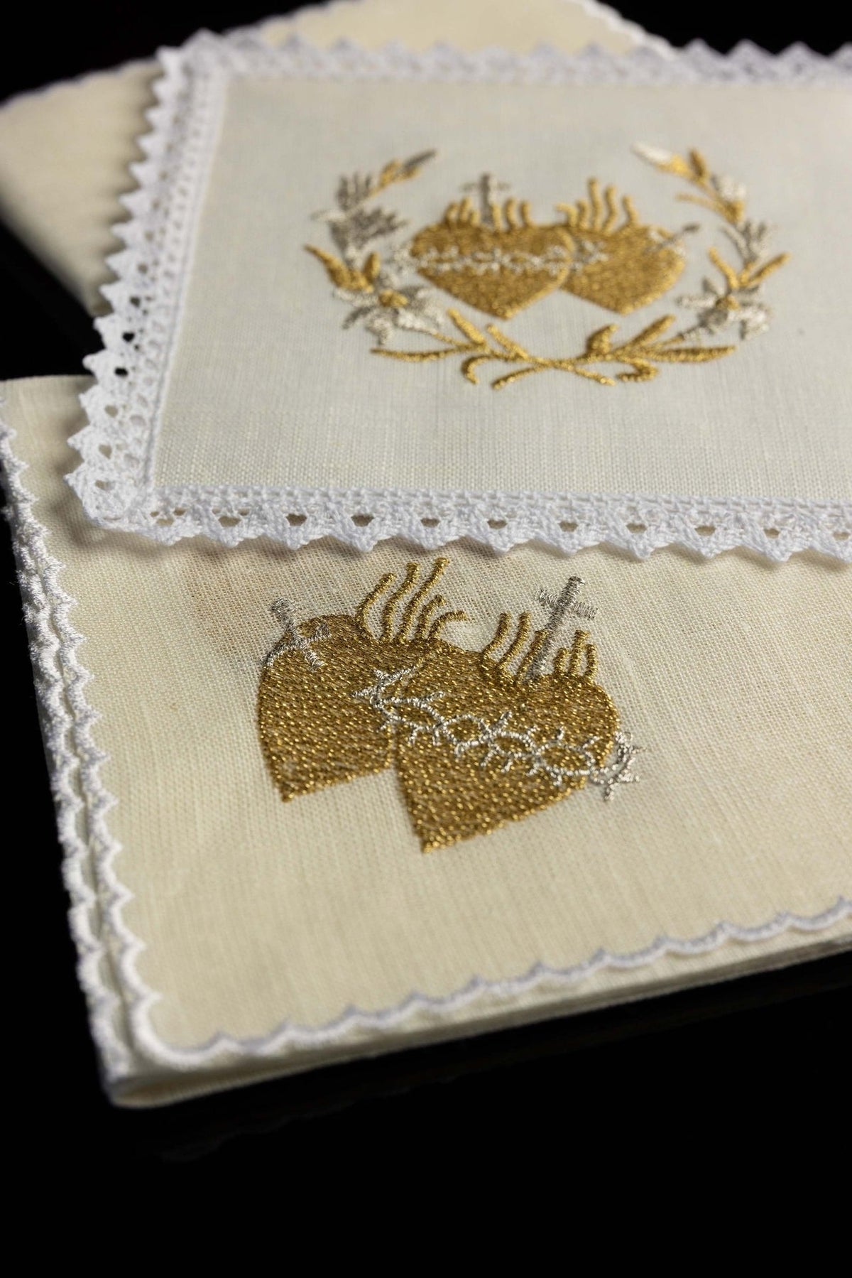 Altar linen set folded, showing lace edging and gold Sacred Heart embroidery