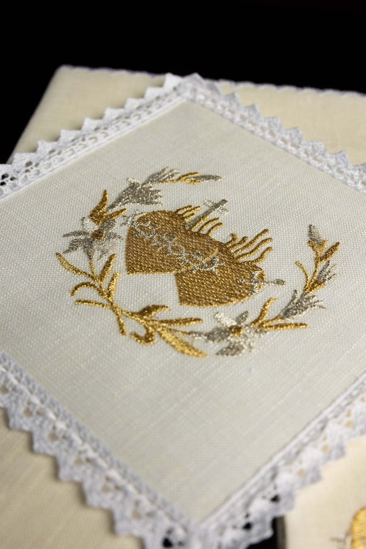 Altar linen set close-up of gold and silver Sacred Heart embroidery framed by floral branches