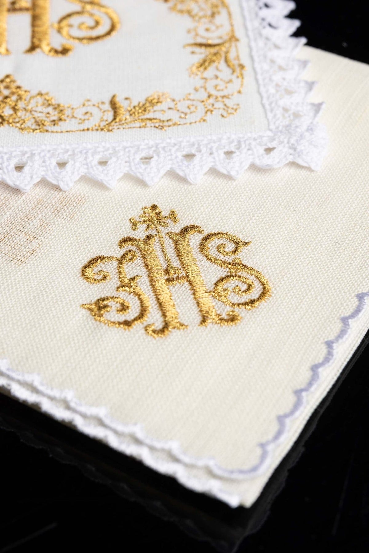 Altar linen set detail showing gold IHS embroidery and scalloped white lace edge