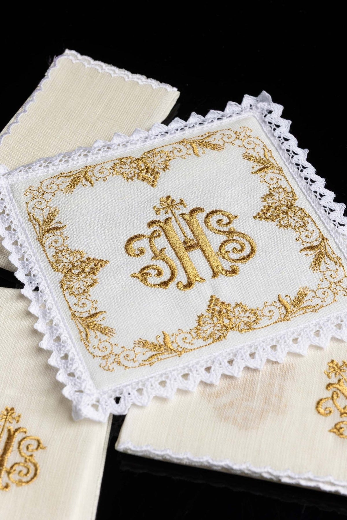 Altar linen set close-up showing gold IHS embroidery on white linen