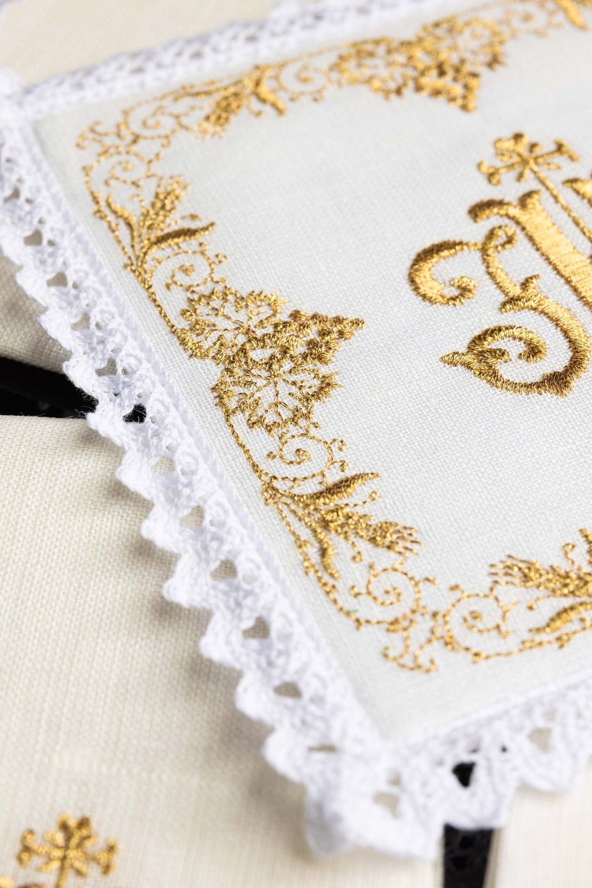 Altar linen set close-up showing gold floral embroidery and white lace edging