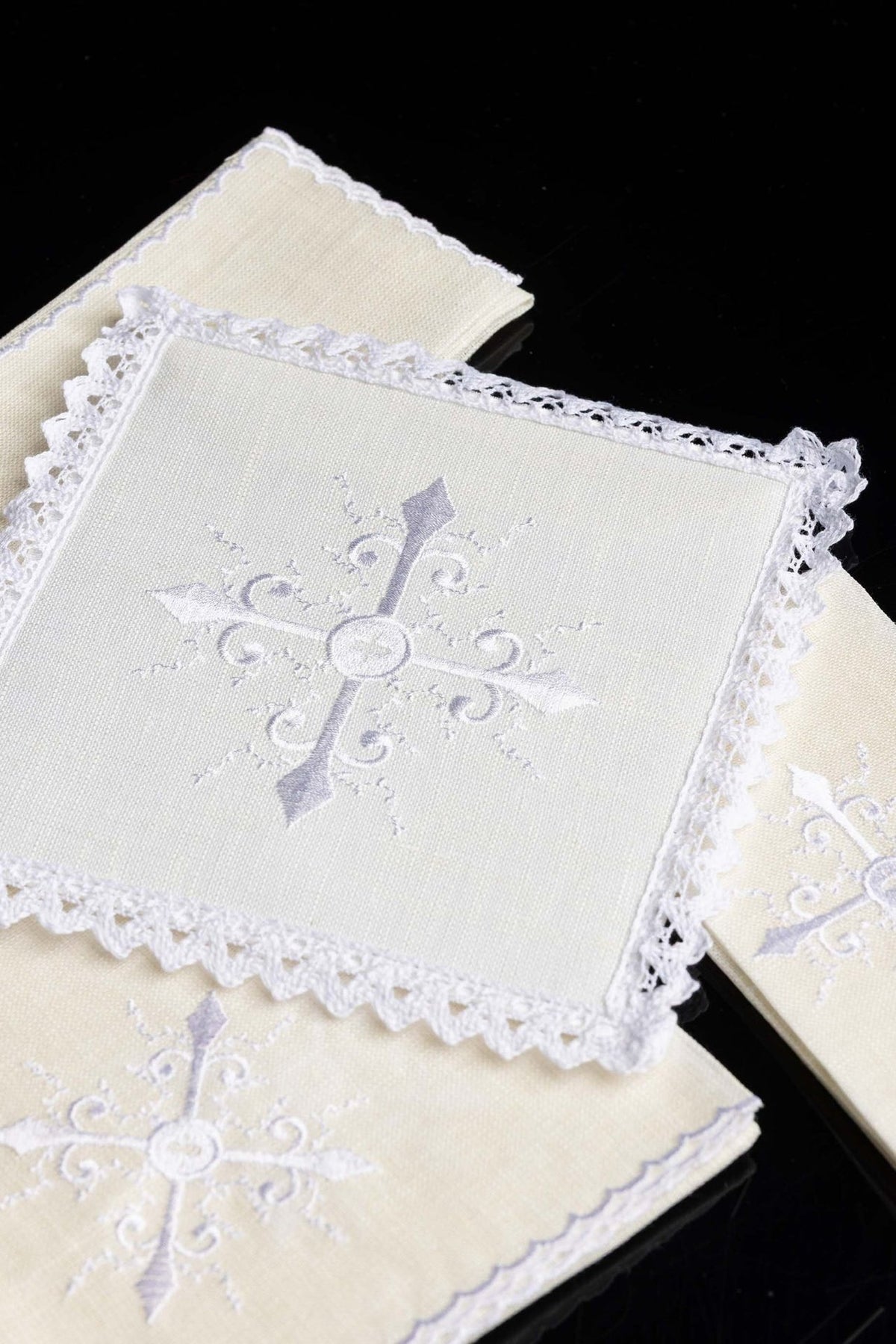 Altar linen set close-up showing ornate cross embroidery and lace edging