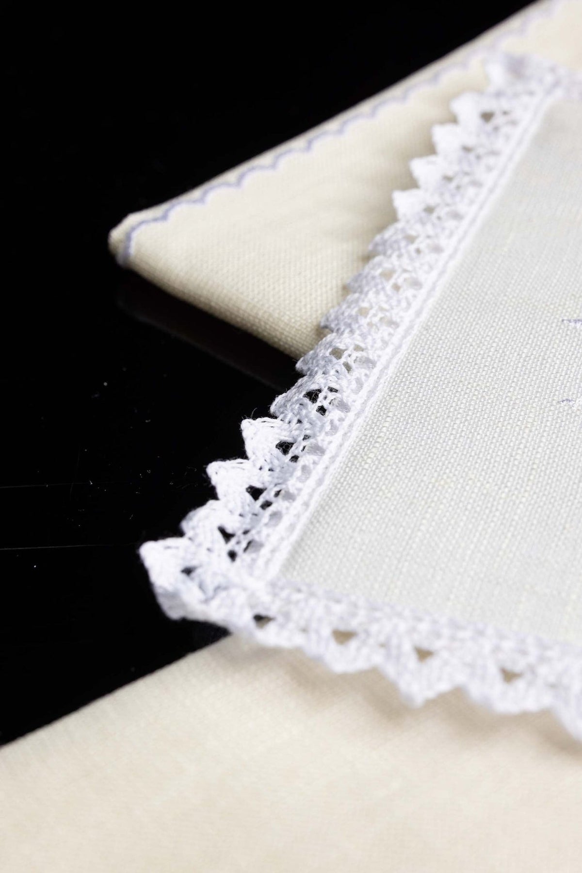 Altar linen set close-up showing textured ivory fabric and decorative lace edging
