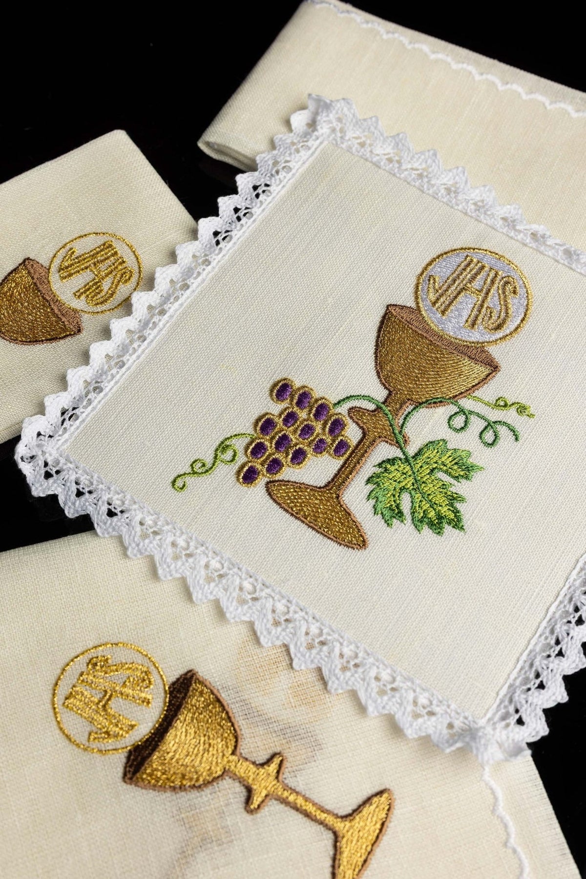 Altar linen set angled view showing cream linen pieces with gold chalice embroidery and lace edges