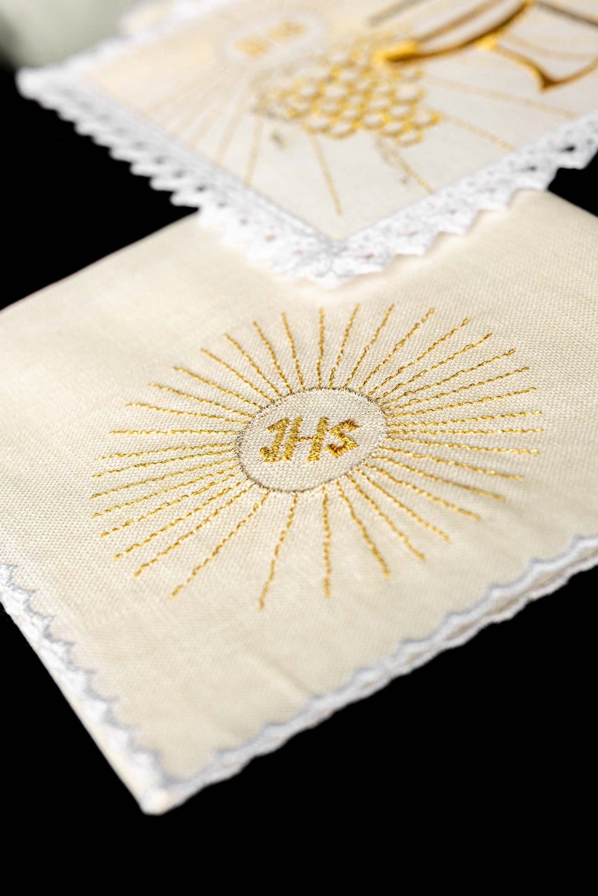 Altar linen set detail showing gold embroidered IHS sunburst on white linen