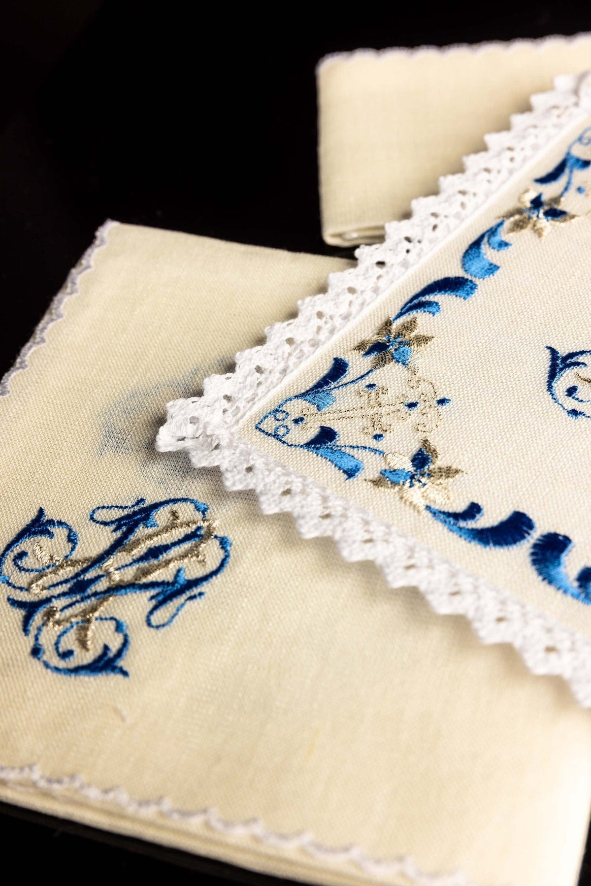 Altar linen set detail showing embroidered blue Marian motif on linen