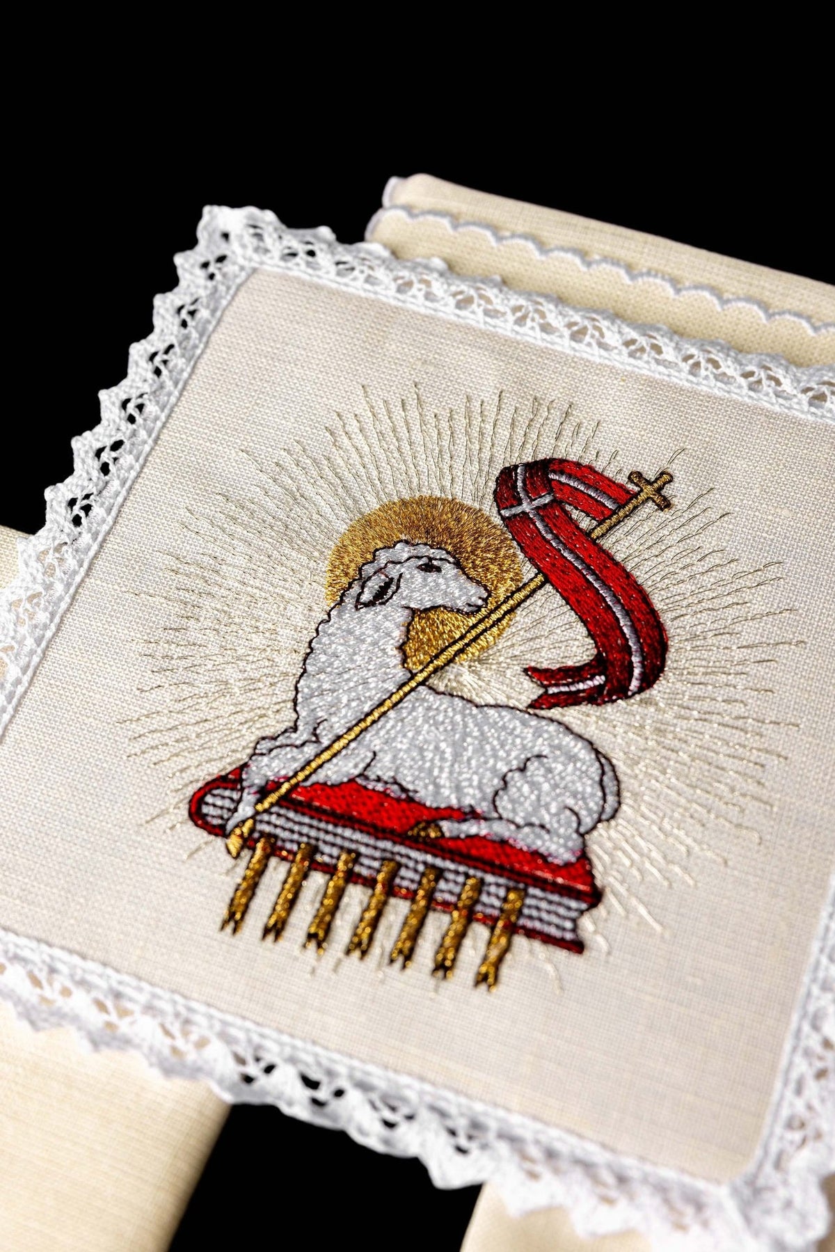 Altar linen set close-up showing embroidered Agnus Dei motif and white lace trim