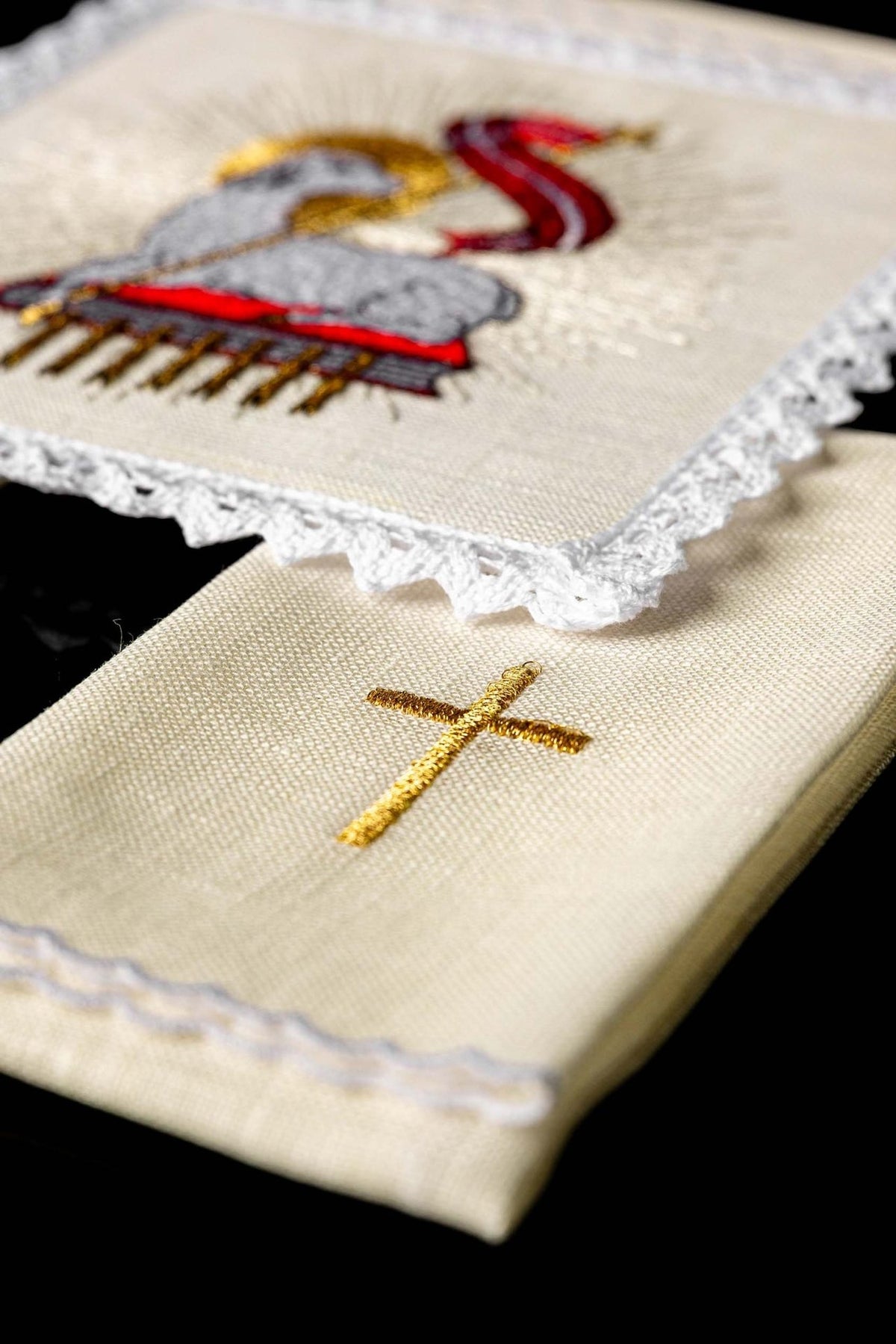 Altar linen set detail showing gold embroidered cross on cream linen