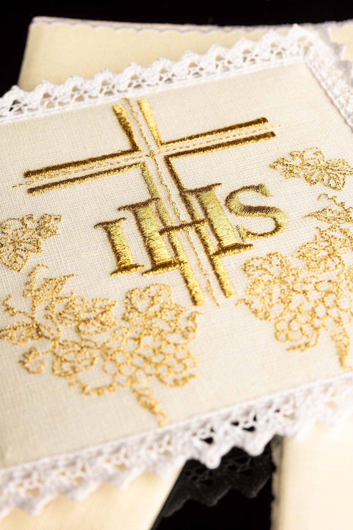 Altar linen set close-up showing gold IHS and cross embroidery with grape motifs