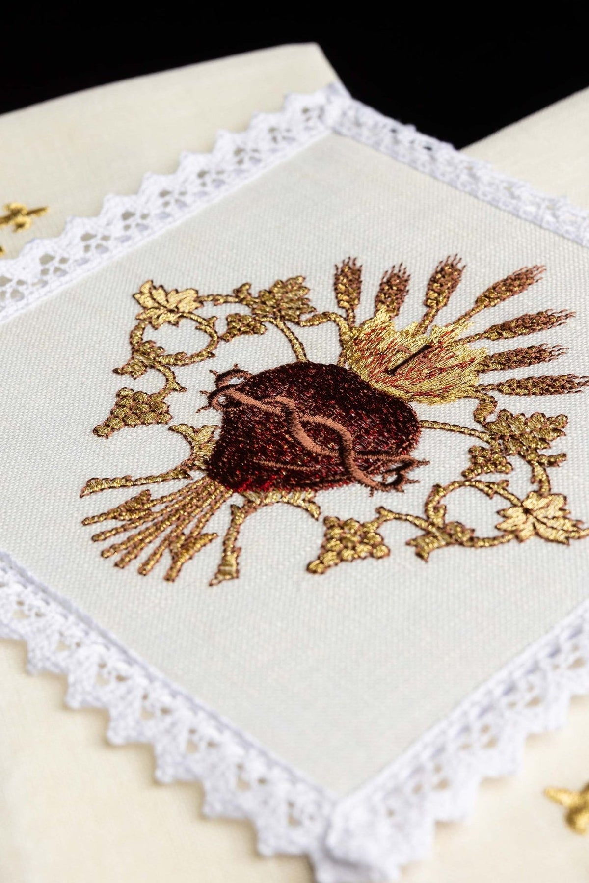 Altar linen set detail showing the Sacred Heart of Jesus embroidery and lace trim