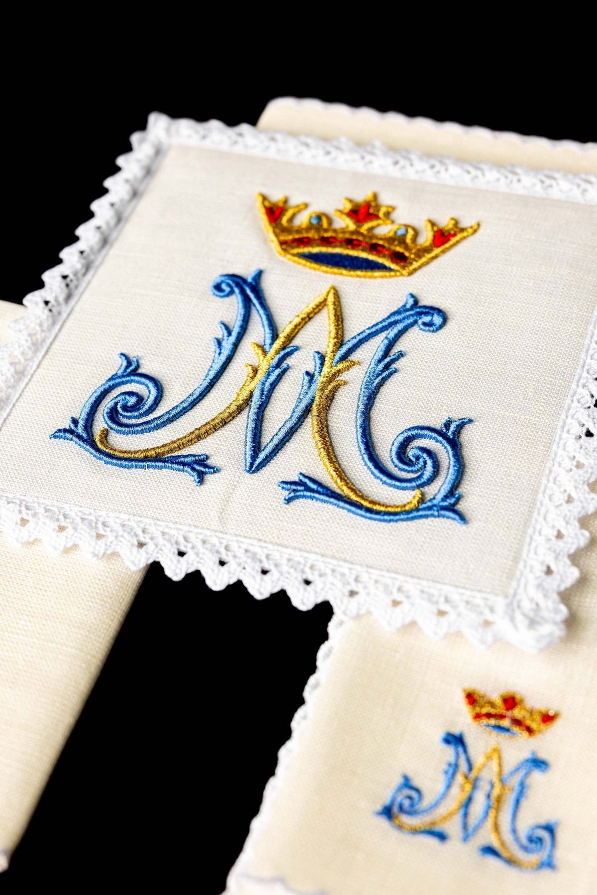 Altar linen set close-up showing blue and gold Marian embroidery with crown and lace trim