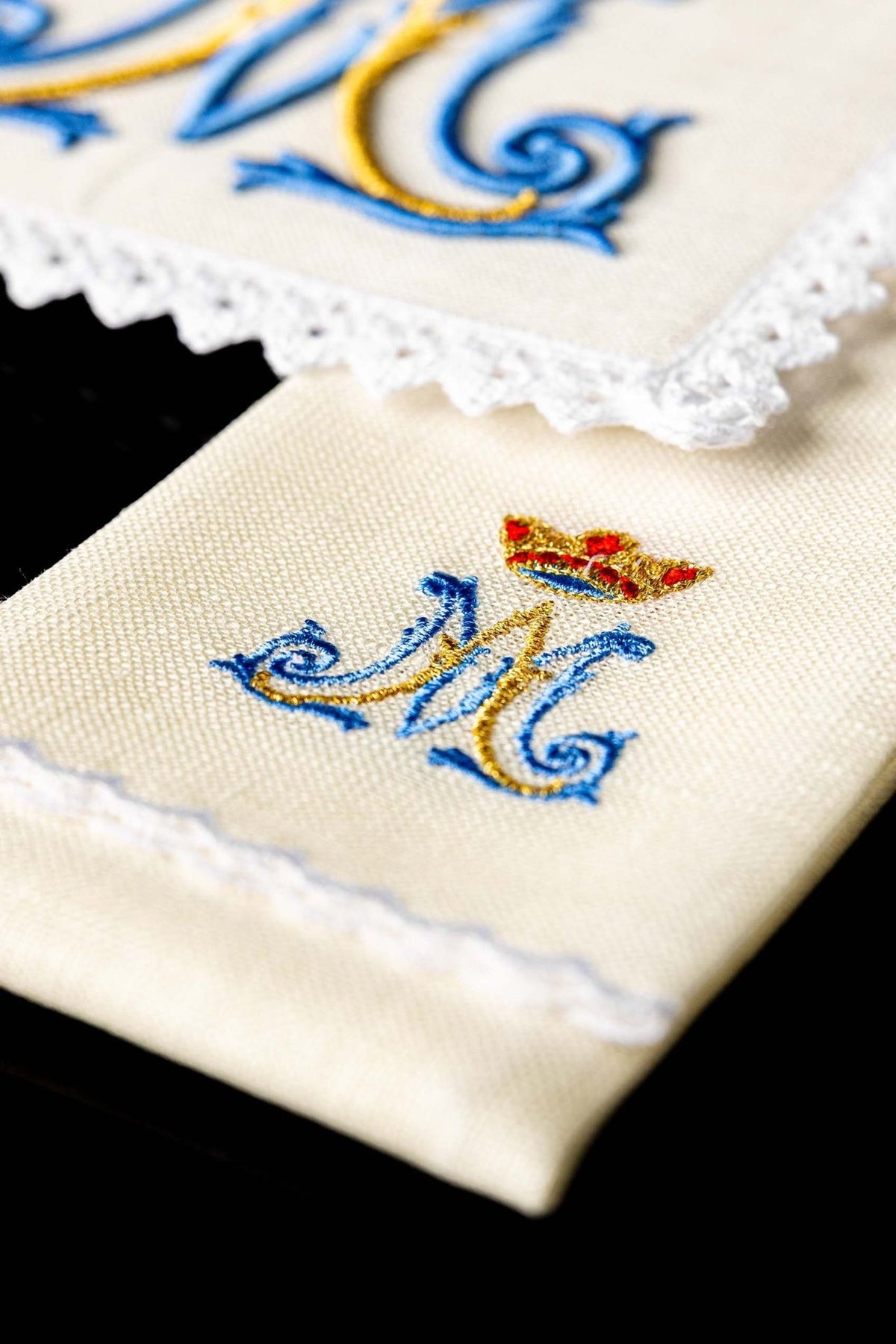 Altar linen set detail showing embroidered Marian motif with crown on ecru linen