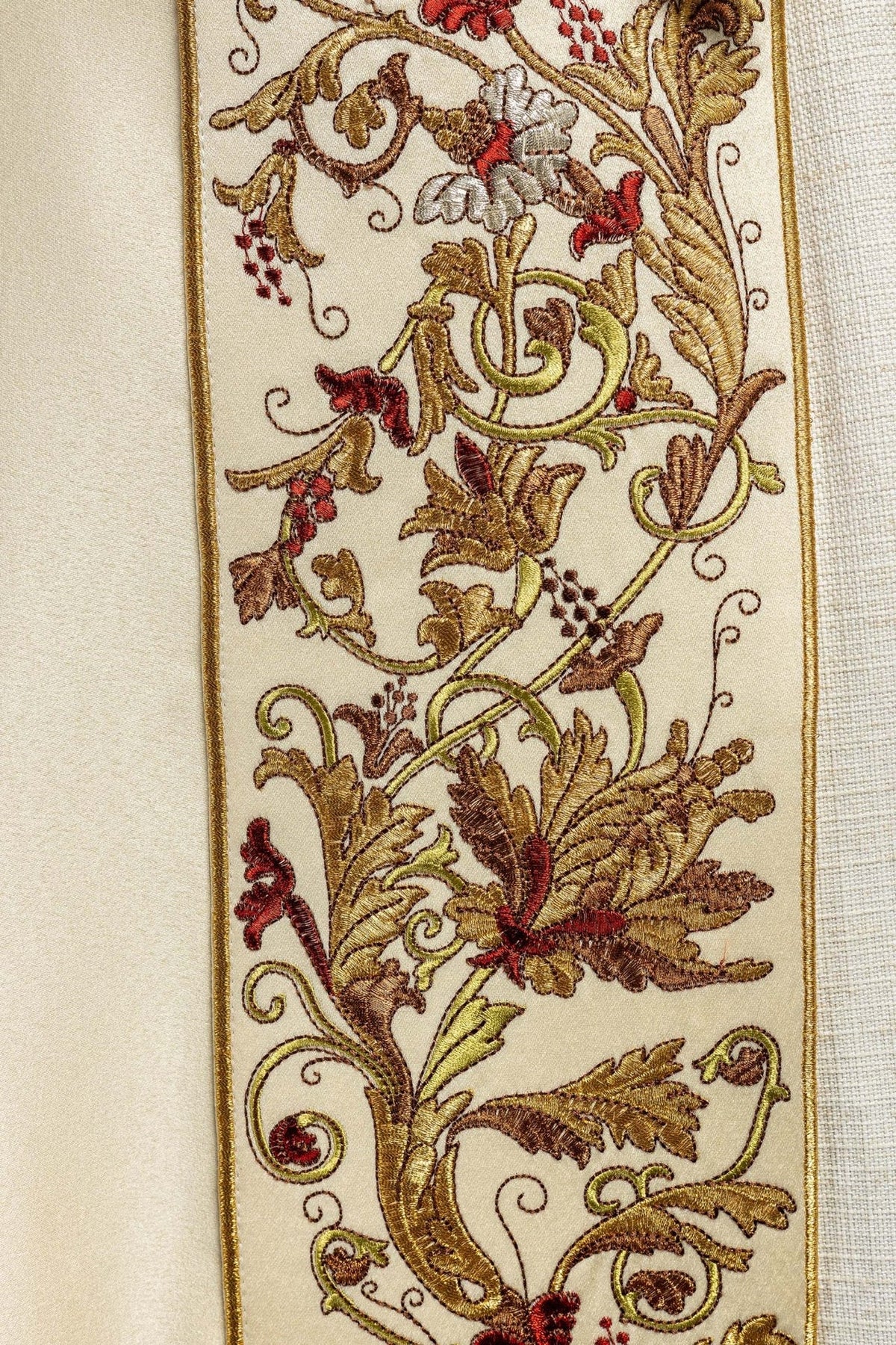 Ecru satin cope, close-up of floral embroidery and gold edging