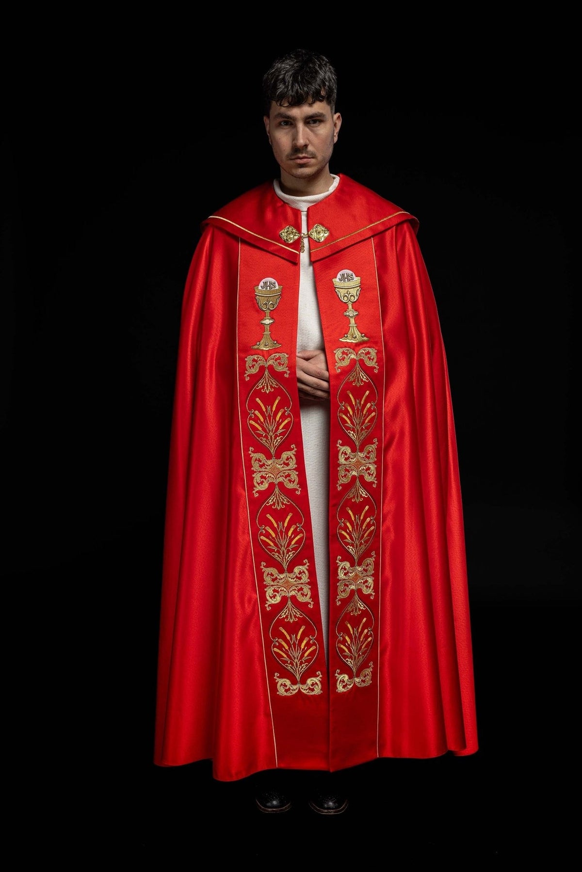 Red cope front view with matching chalice and IHS embroidery on both panels