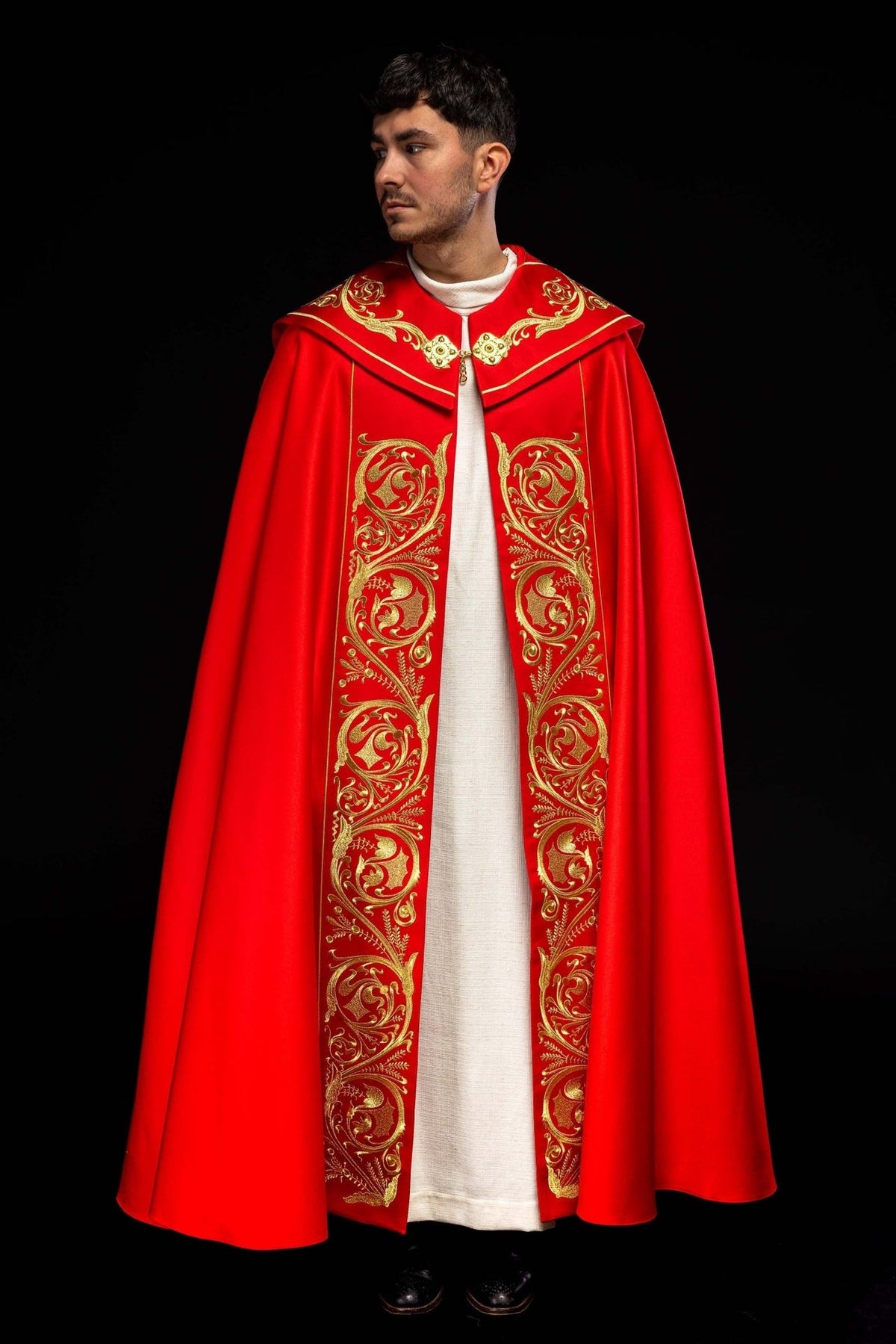 Red cope, full front view with rich gold embroidery on the edges