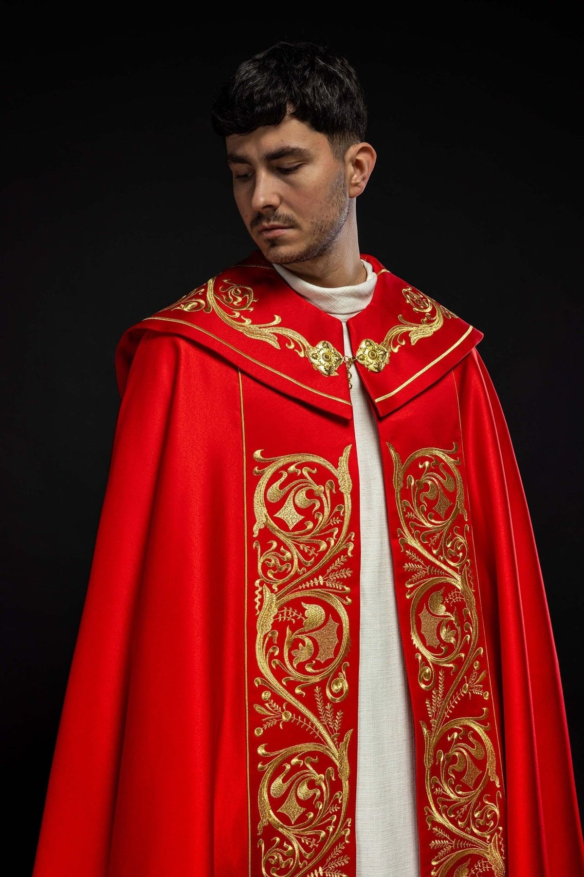 Red cope, front view showing ornate gold embroidery and clasp