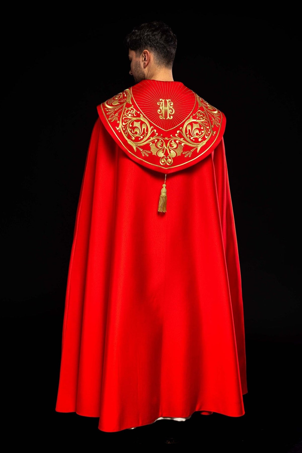 Red cope, detail of gold cross embroidery on the sleeve and front panel