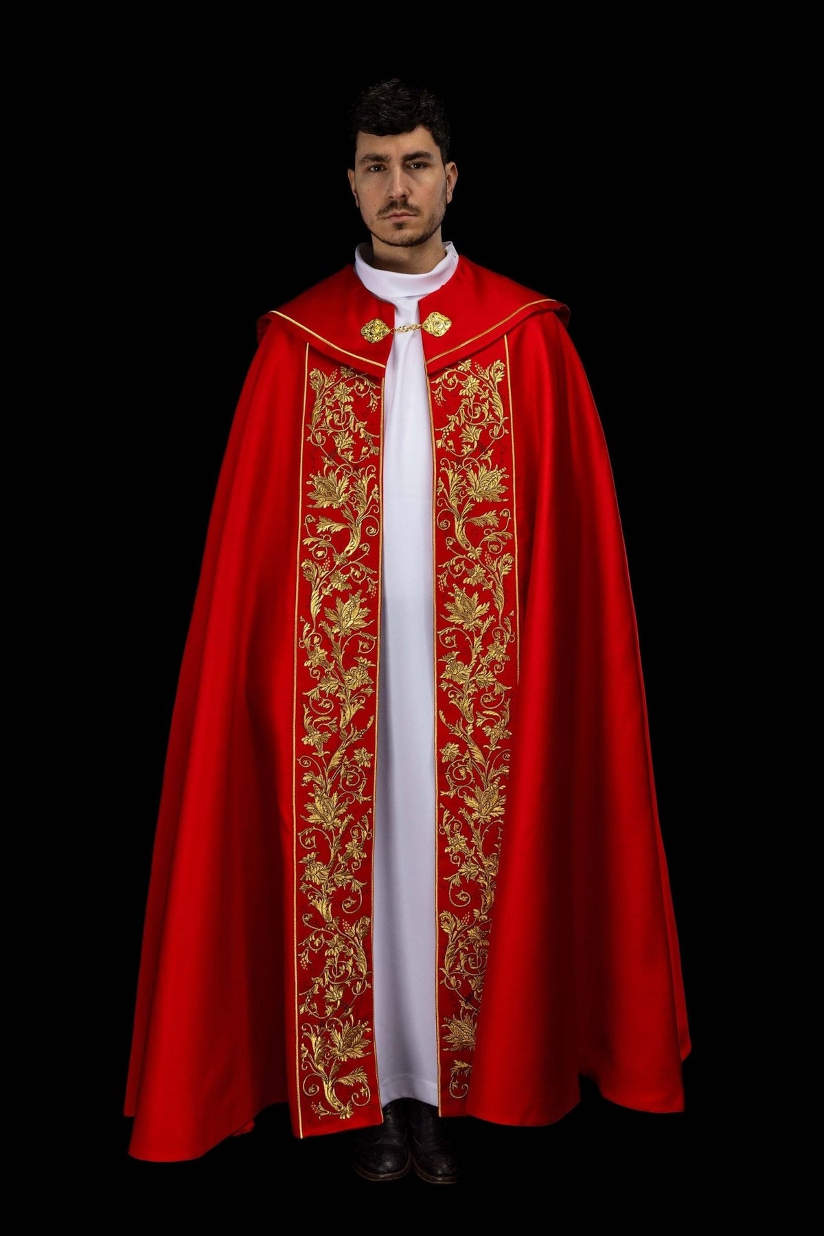 Red liturgical cope side view with embroidered back panel and gold trim