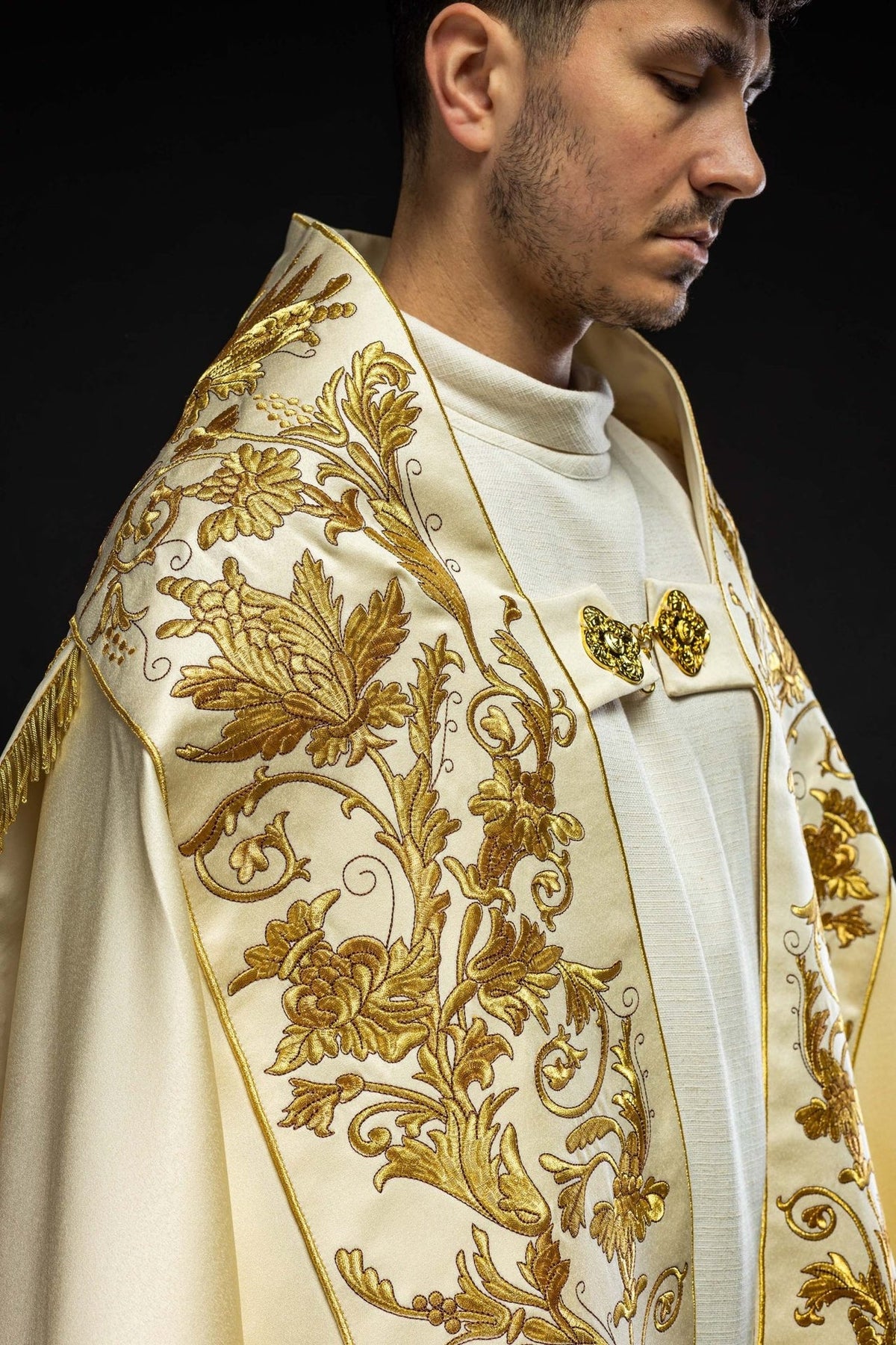 Ecru satin cope, side view showing gold floral embroidery and raised collar