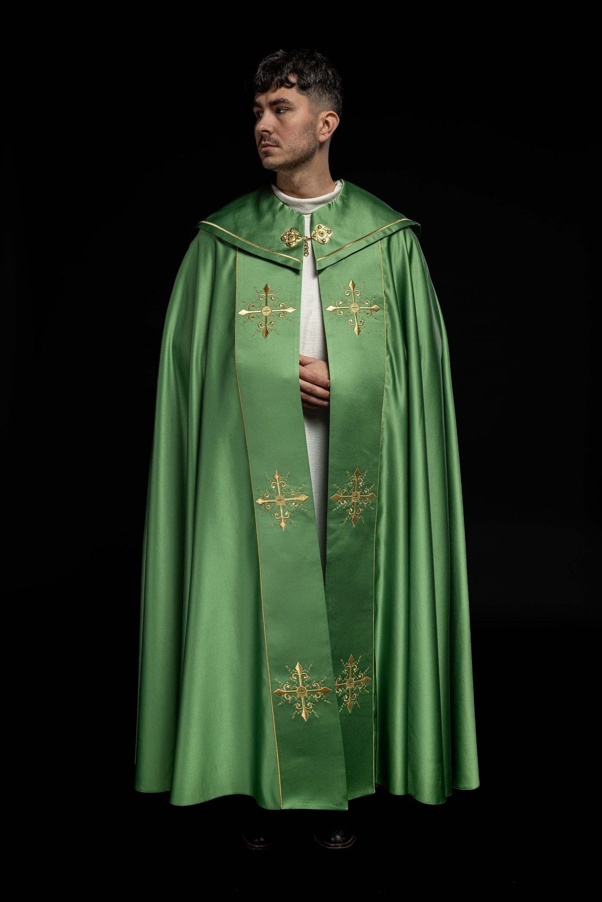 Green cope full front view with wide orphrey and gold cross embroidery