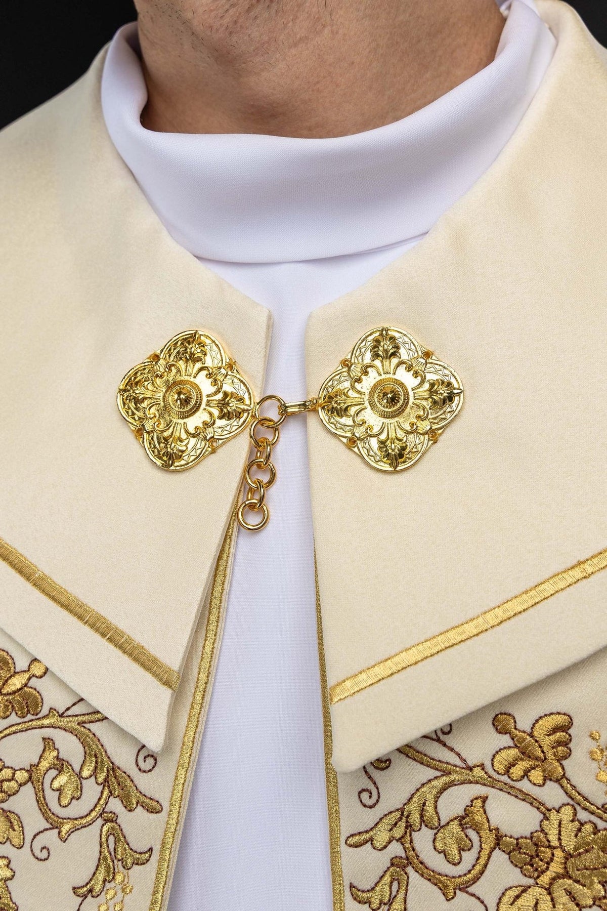 Ecru cope close-up of gold floral clasps and embroidered panels