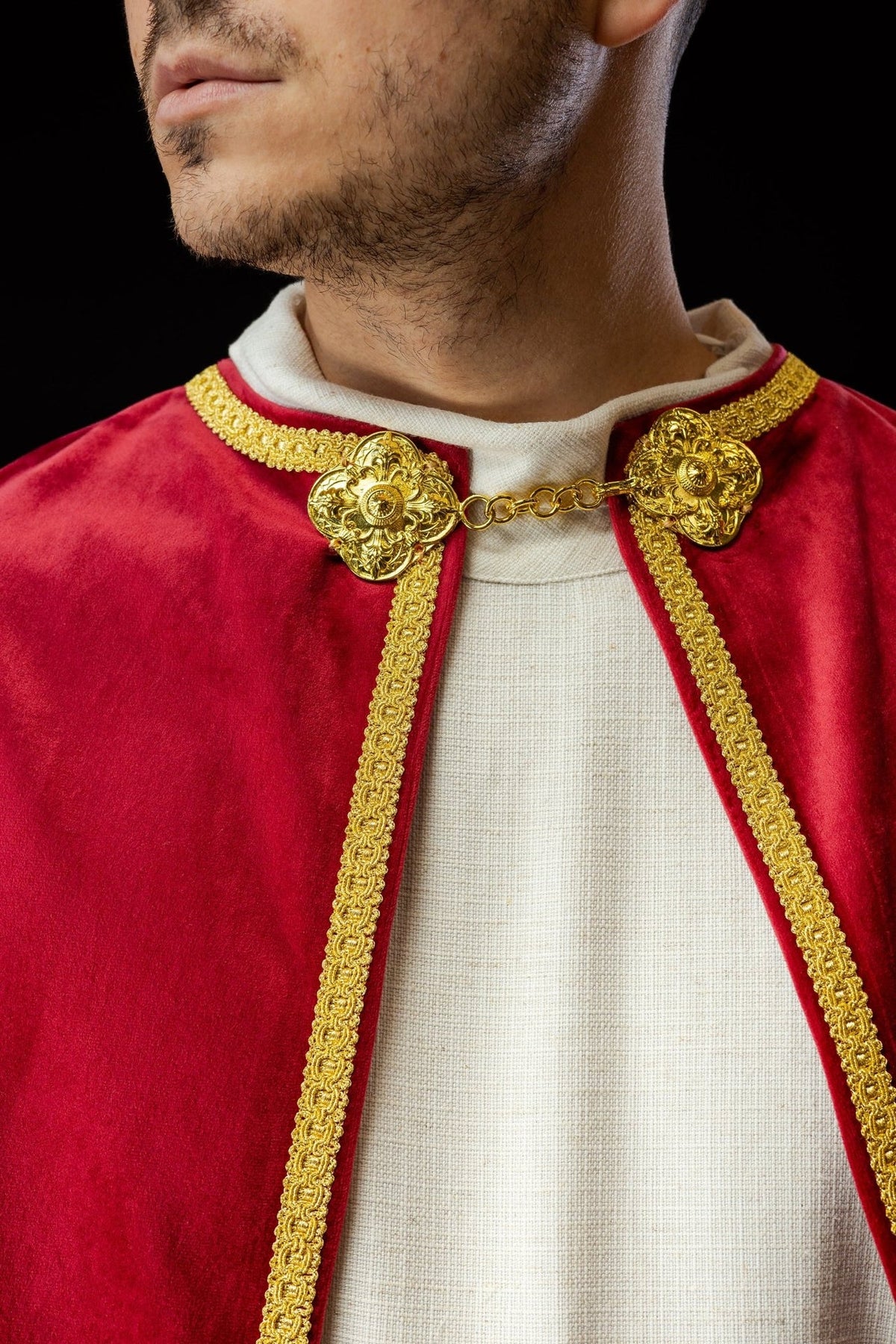 Red velvet altar server cape, close-up of gold clasp and collar trim