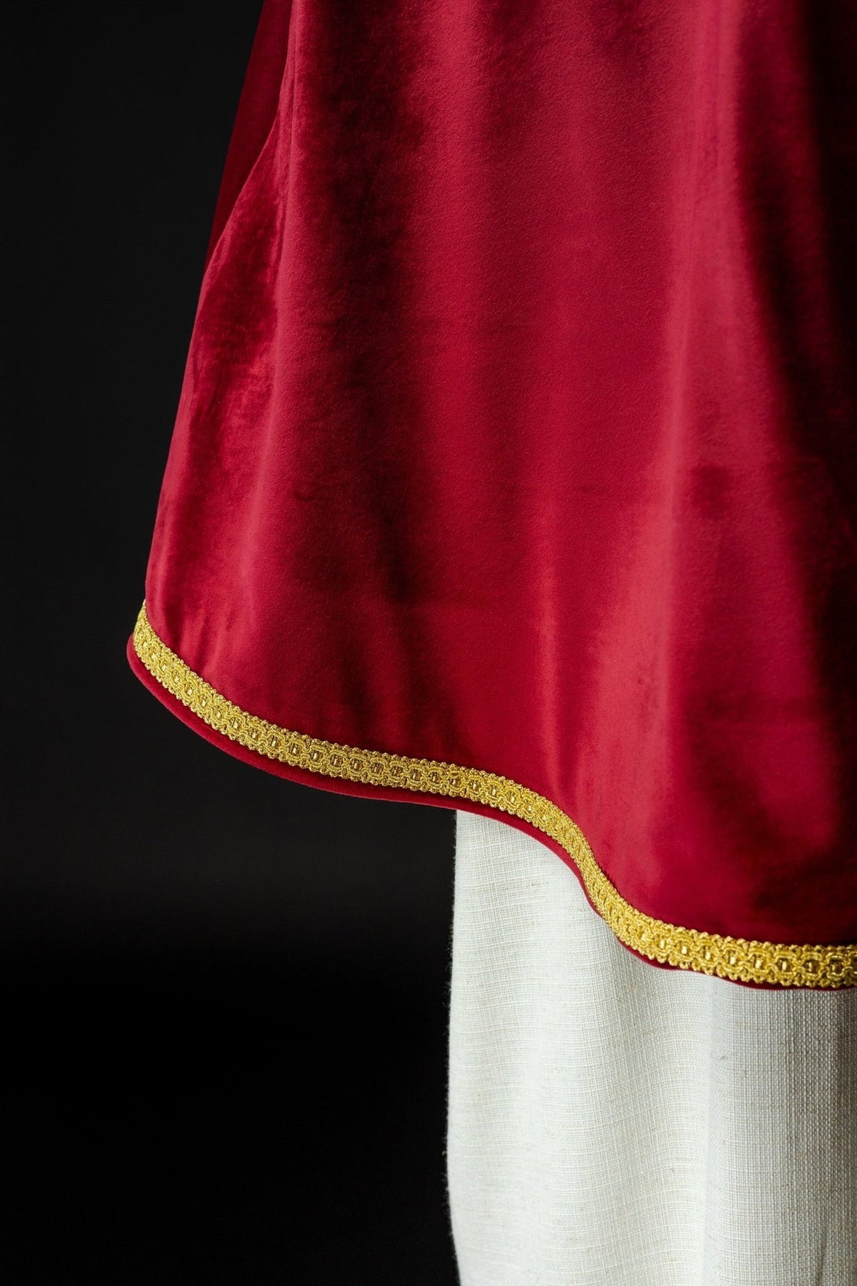 Red velvet altar server cape, side close-up with gold trim