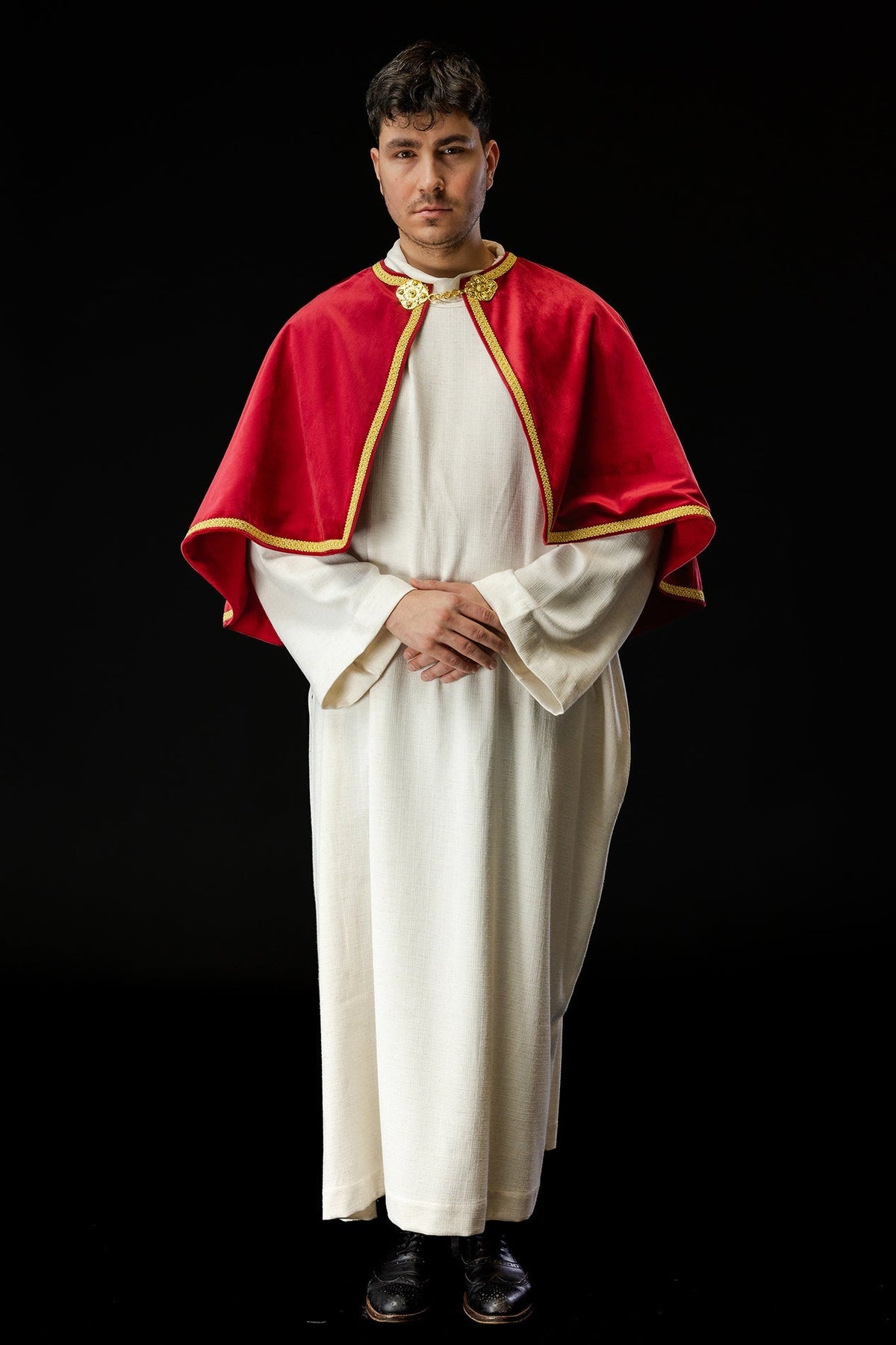 Red velvet altar server cape, front three-quarter view with gold clasp