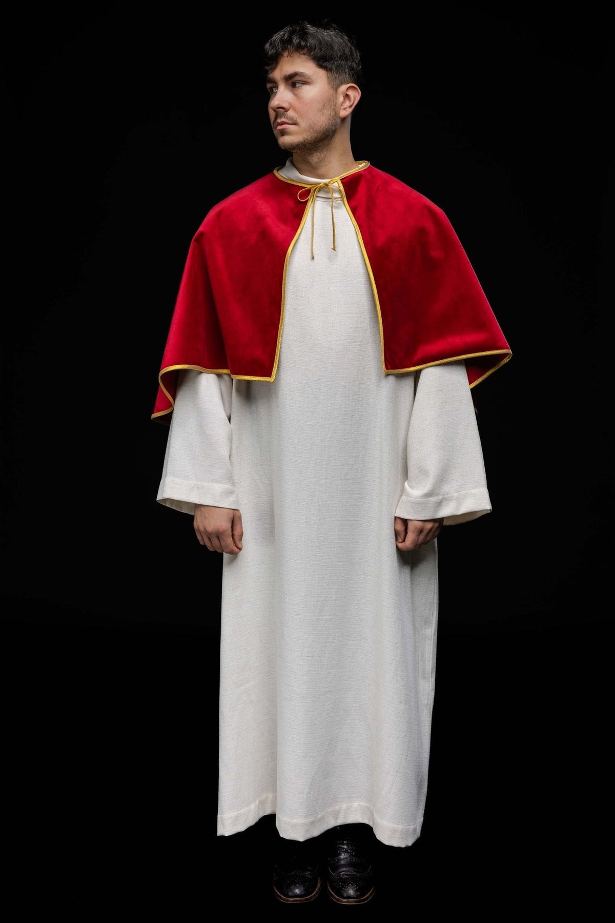 Red altar server cape worn in a full front view with gold trim and tie closure