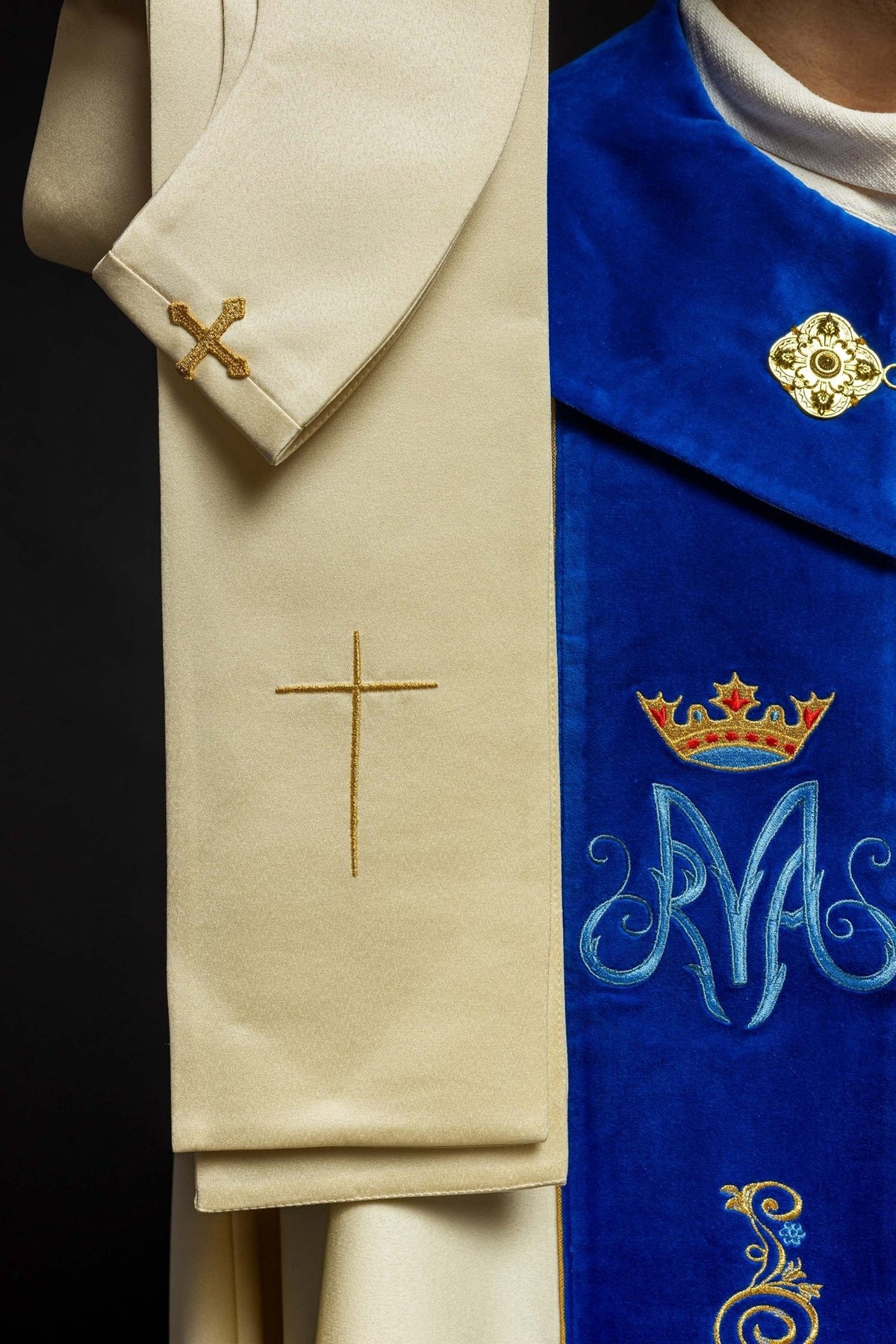 Marian cope detail showing gold and blue floral embroidery on the blue velvet orphrey
