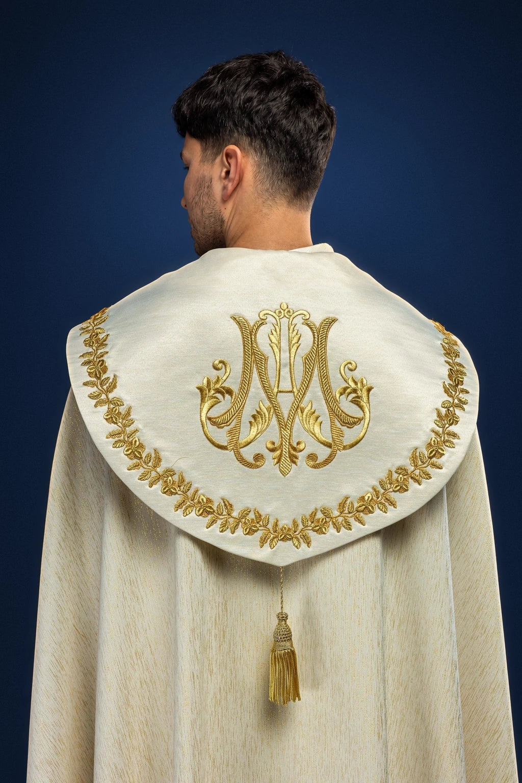 Ecru Embroidered Marian Cope, back view with gold Marian monogram, floral border and tassel