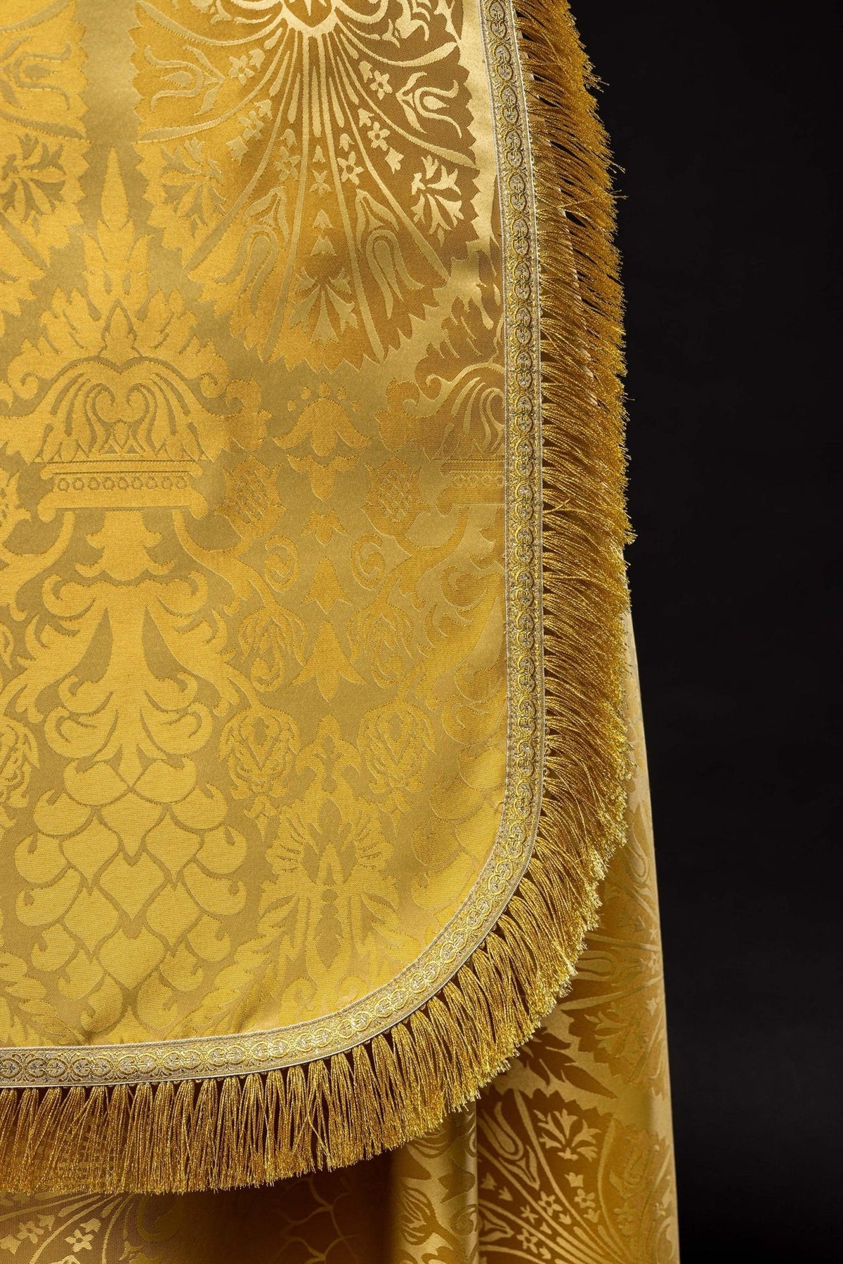 Plain Roman Jacquard Cope close-up in gold with ornate jacquard motifs, trim and fringe